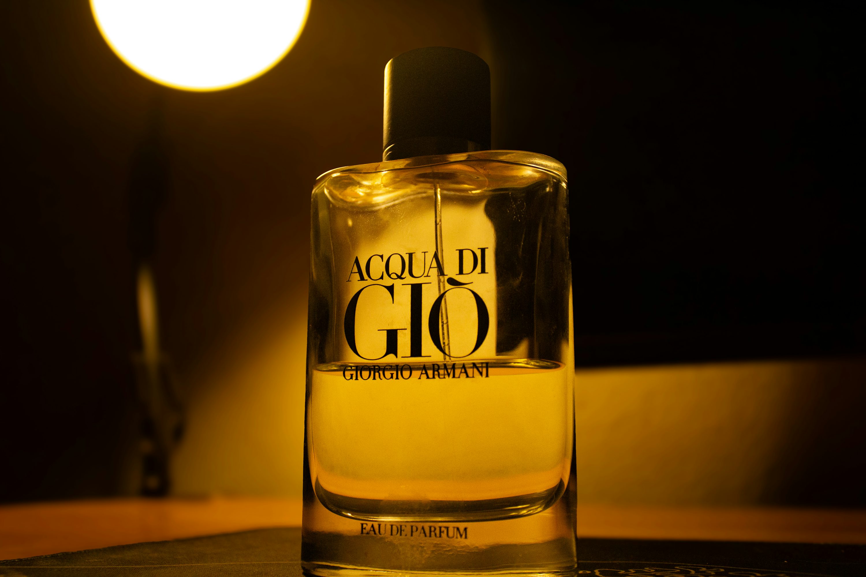 Acqua di gio perfume bottle with warm lighting