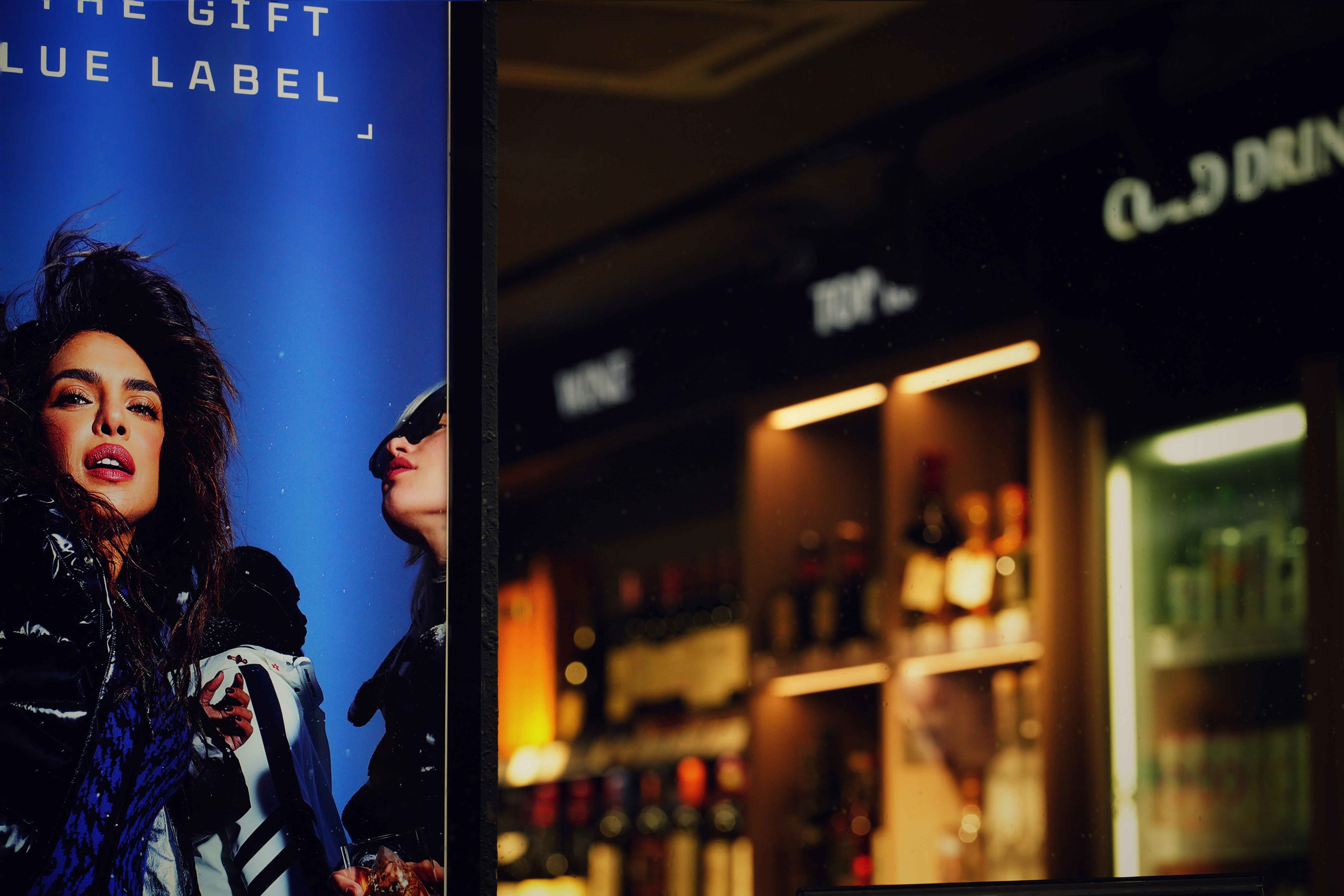 Woman on blue background with bar in background