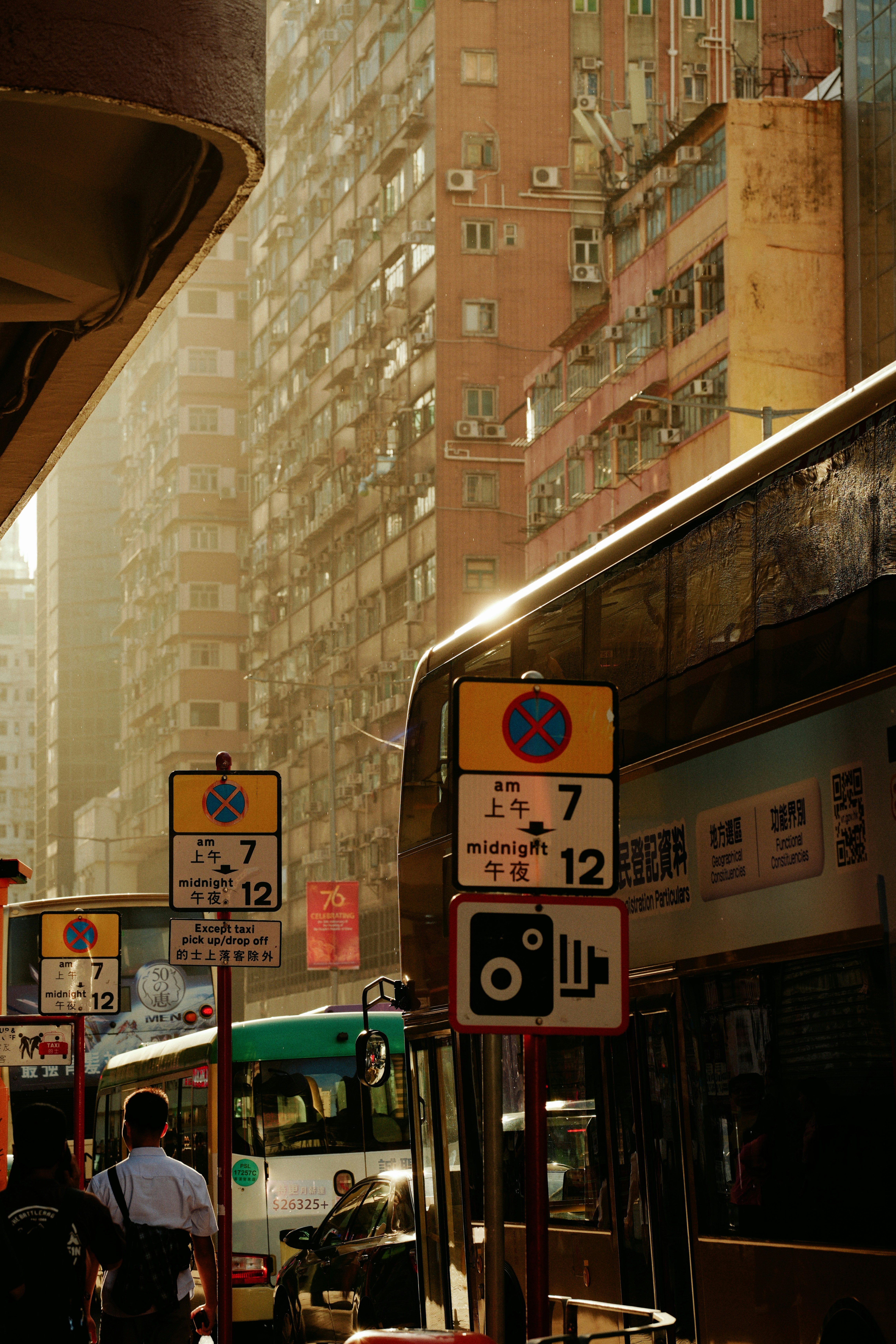Buses and traffic signs on a city street.
