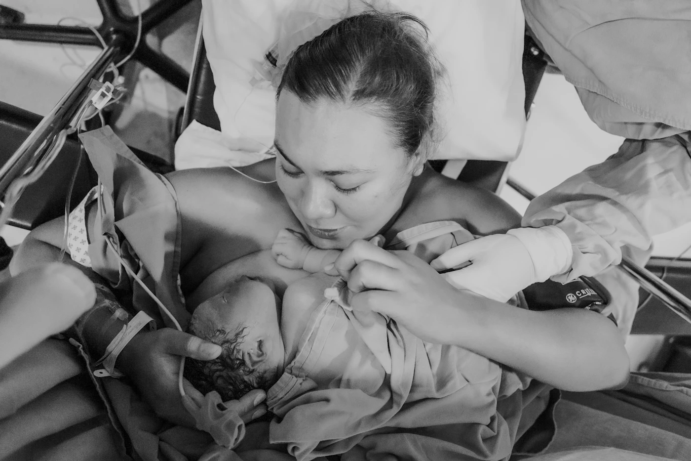 New mother moments after giving birth holding her newborn baby