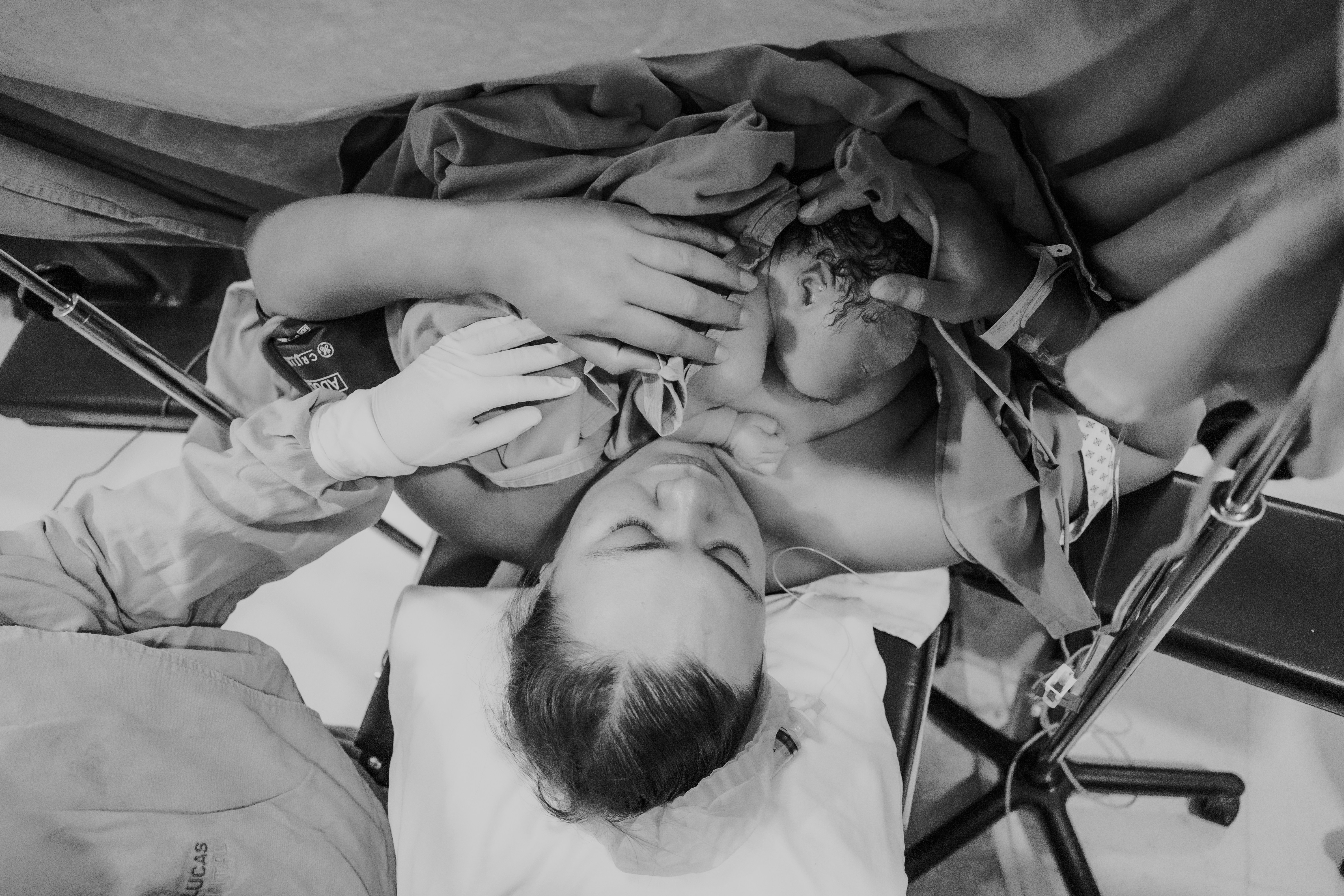 Newborn baby held by parents after birth.