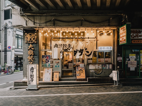 A restaurant storefront lit up at dusk