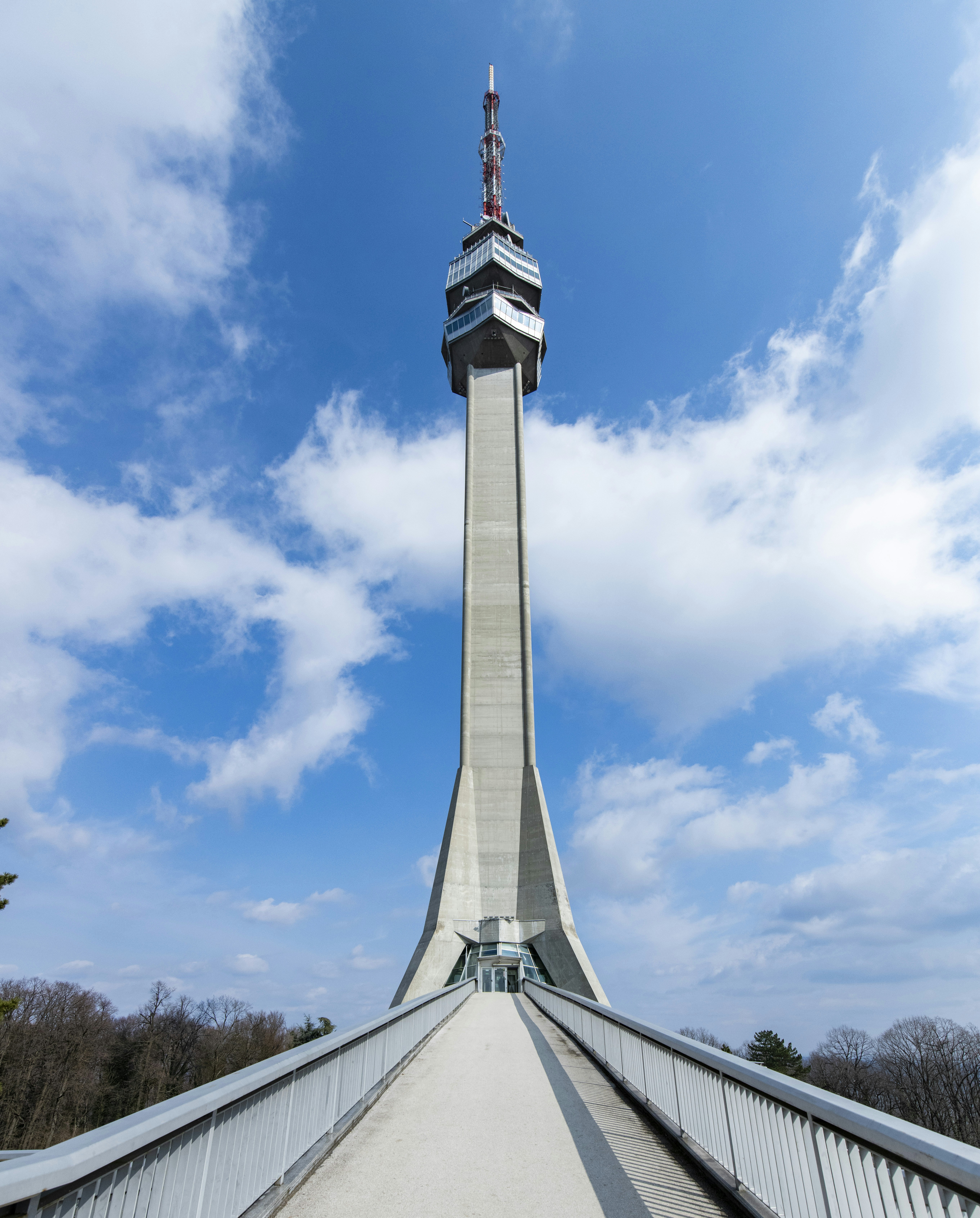 Tall concrete tower against a blue sky with clouds.