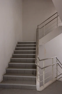 Concrete stairs with metal railings in a building.