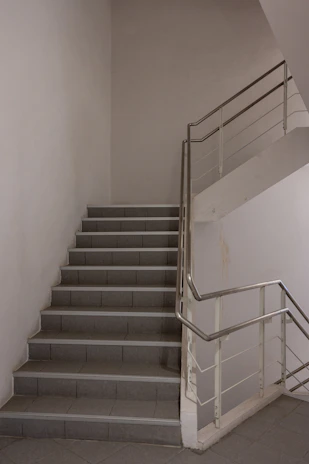 Concrete stairs with metal railings in a building.
