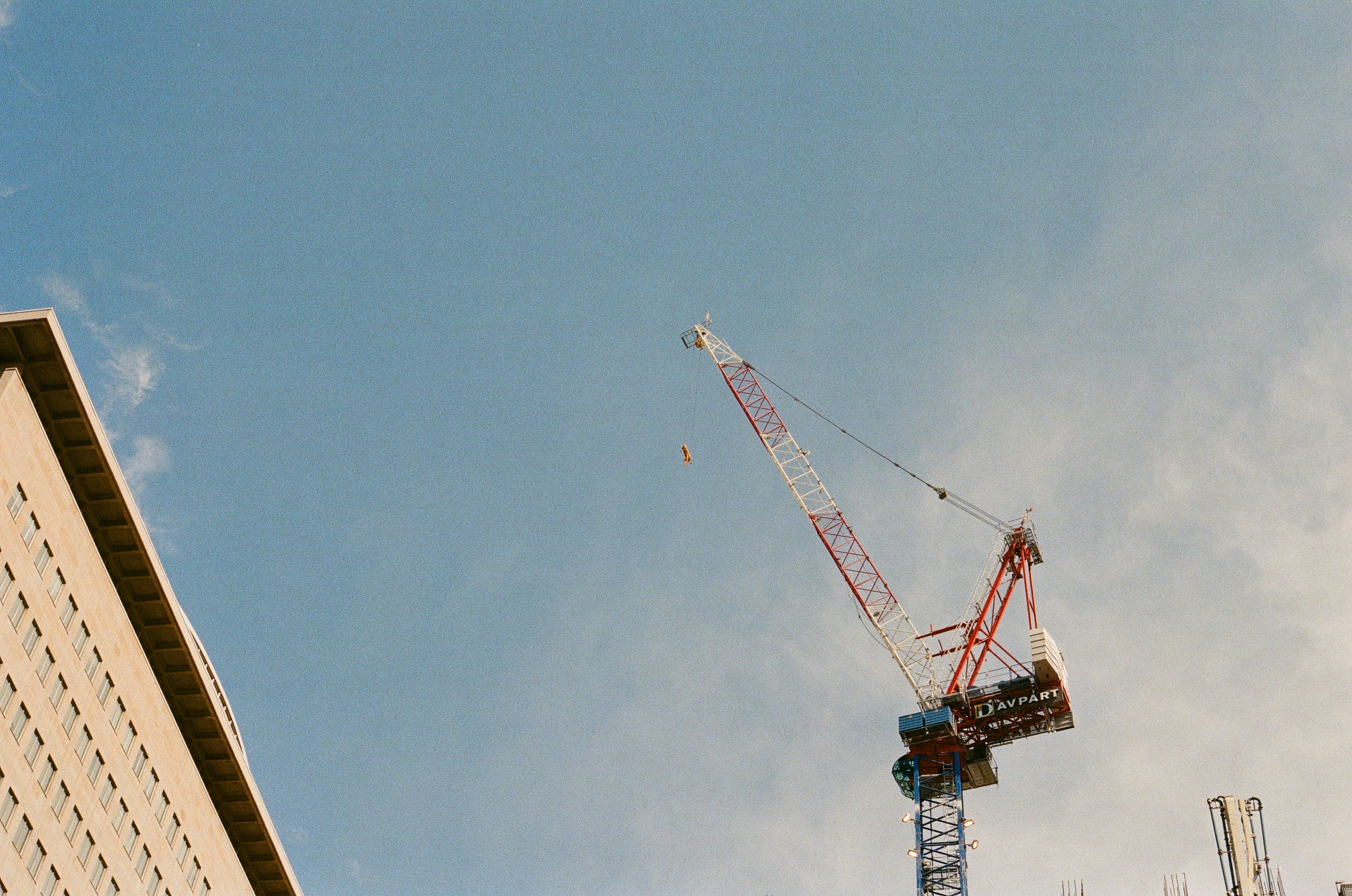 Construction crane against a clear blue sky.