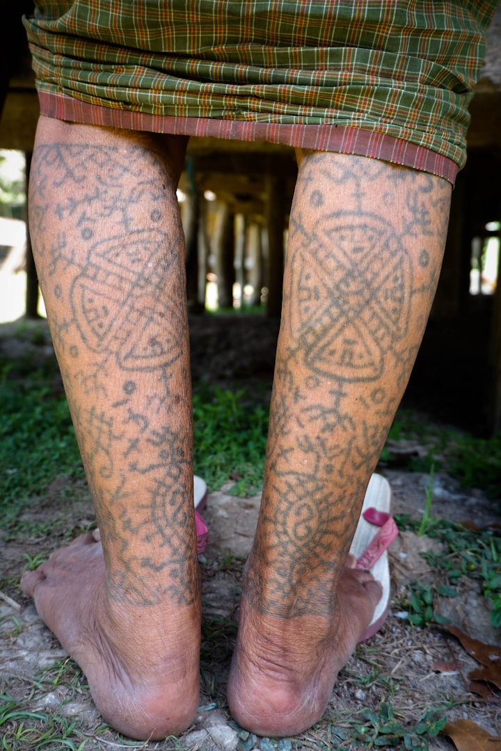 Legs covered in traditional geometric tattoos, evoking the five-pointed star of flash design №001