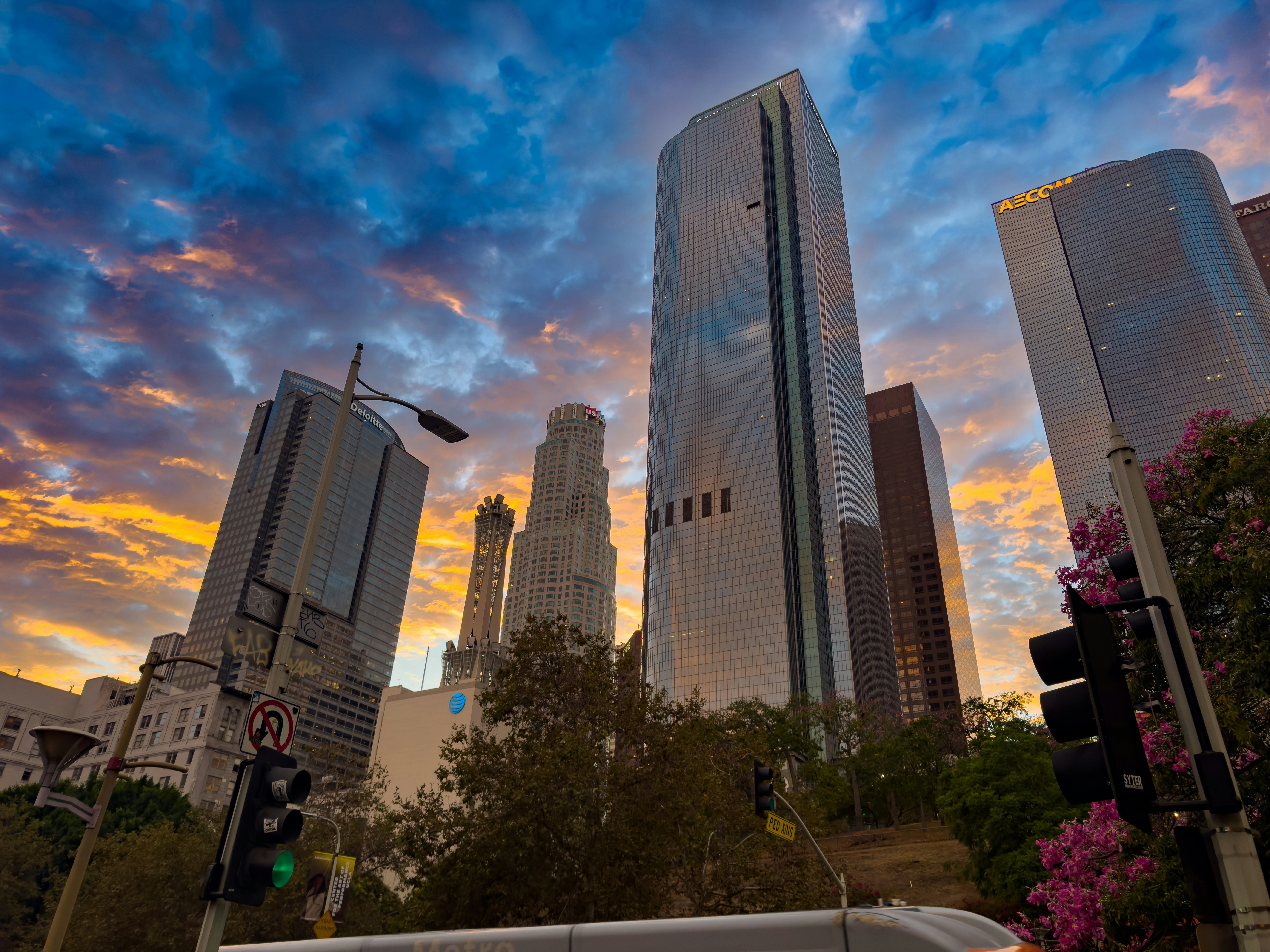 Modern skyscrapers against a dramatic sunset sky