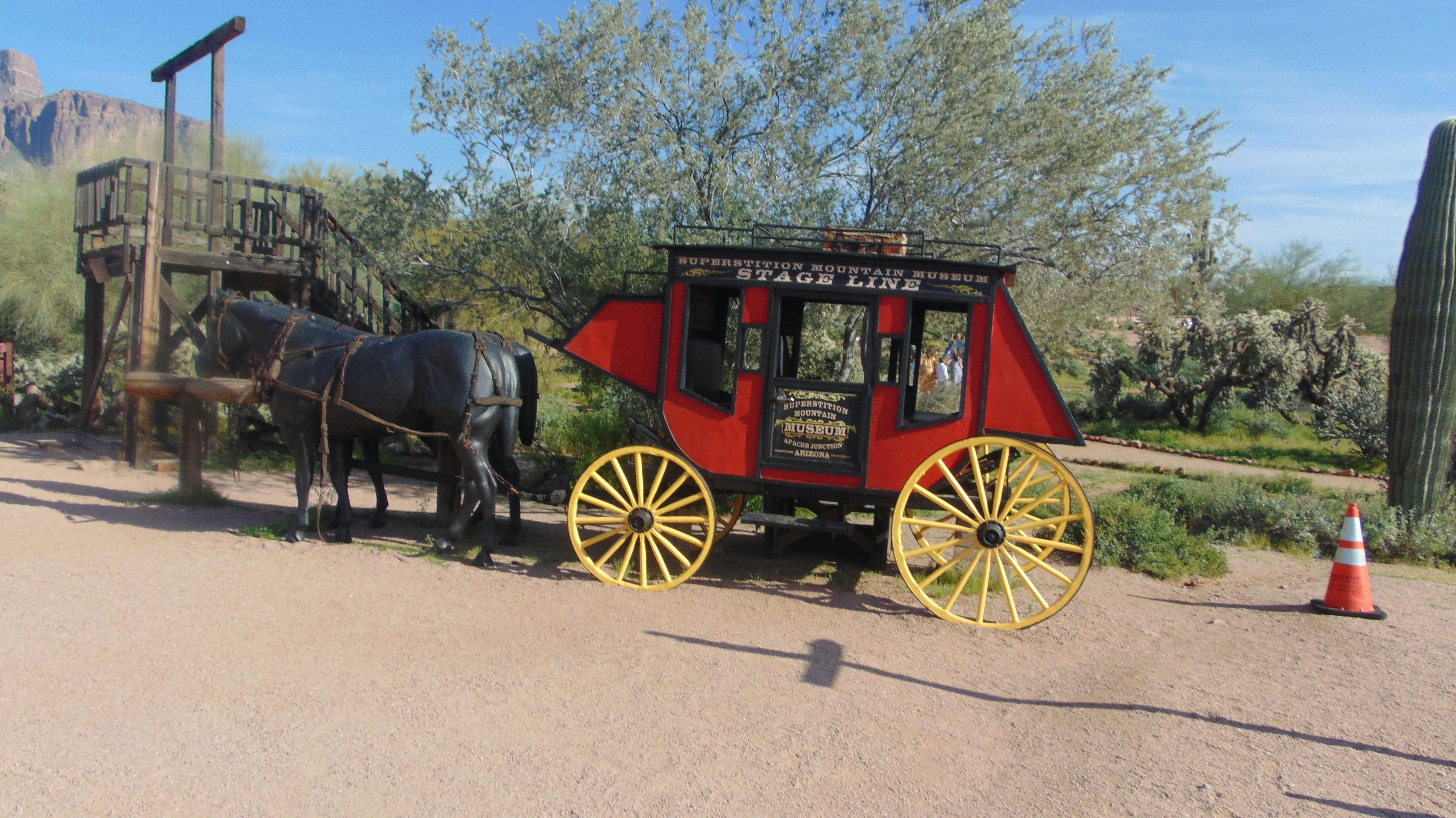 Horse-drawn stagecoach in a desert setting