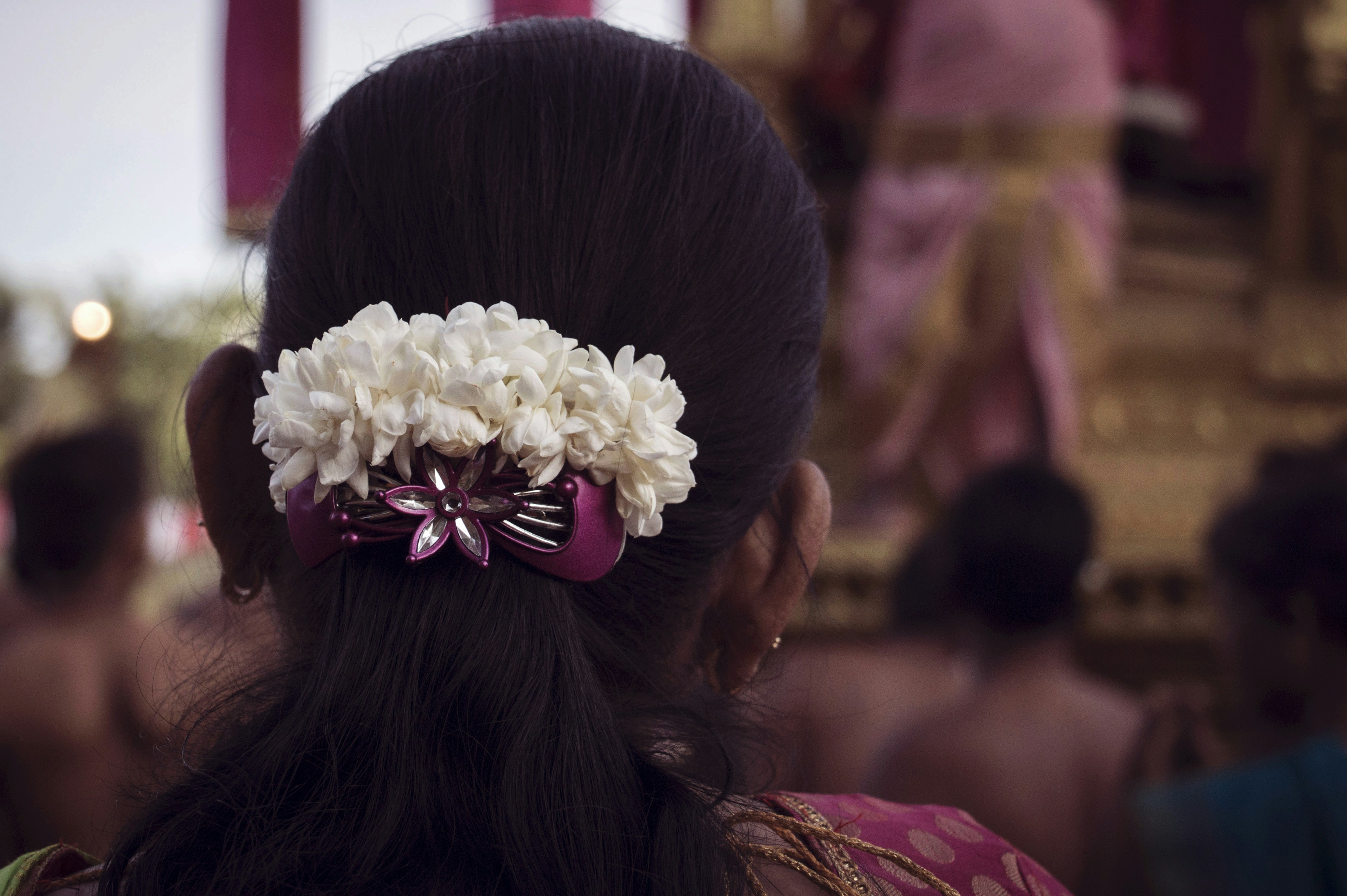 Woman with white flowers in her dark hair