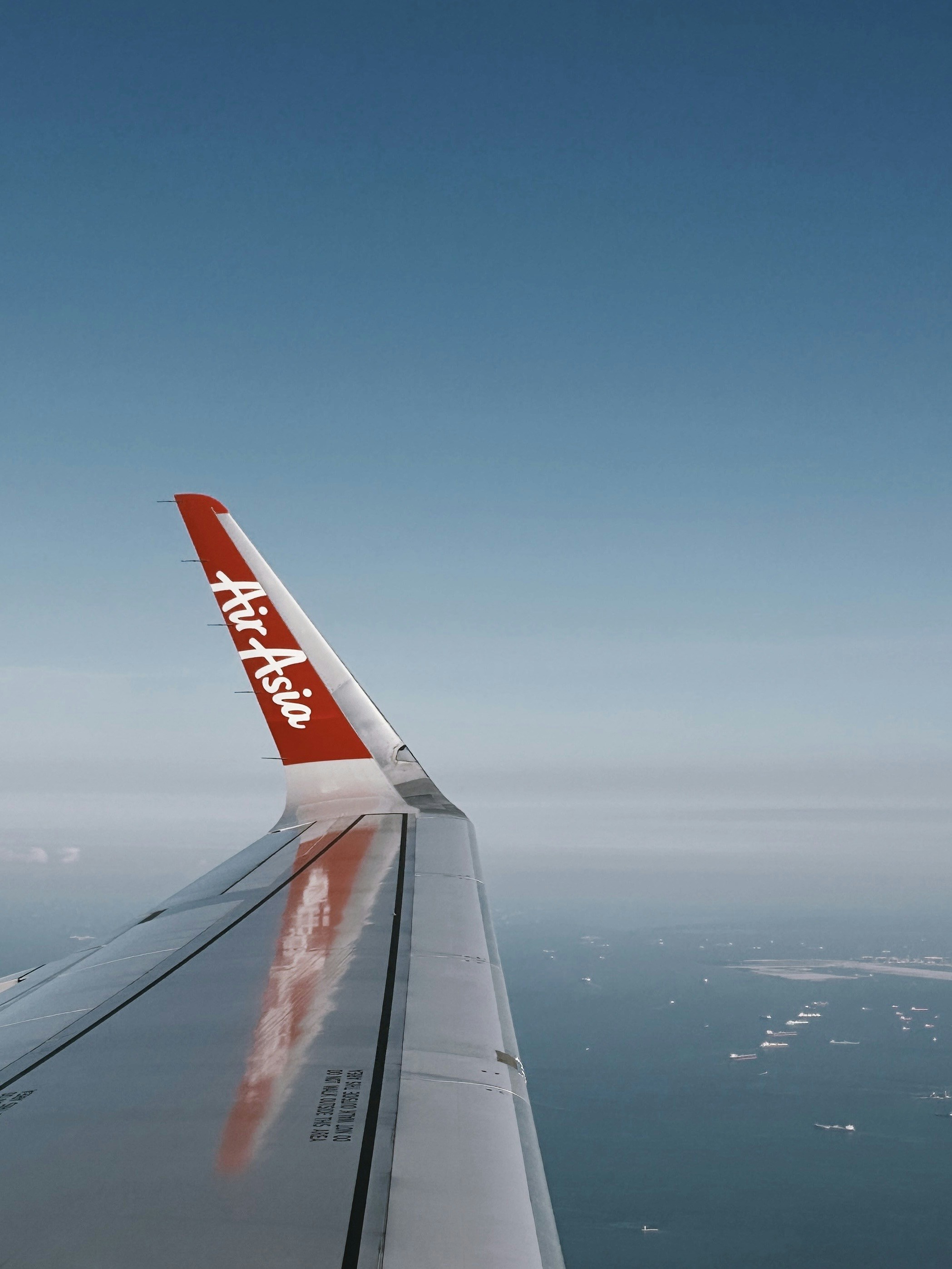 Air asia airplane wing over the ocean