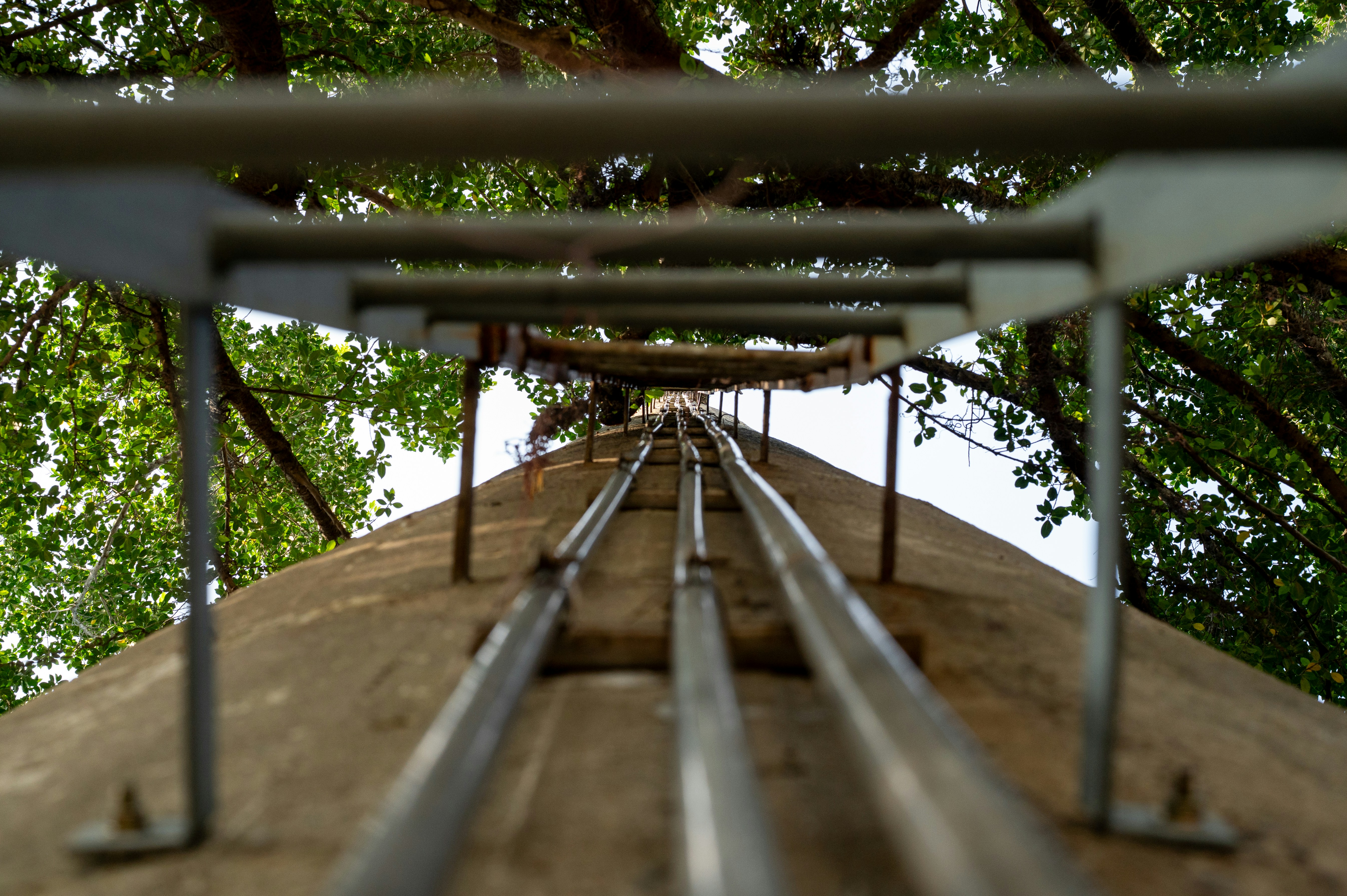 Looking up a concrete structure with metal rails