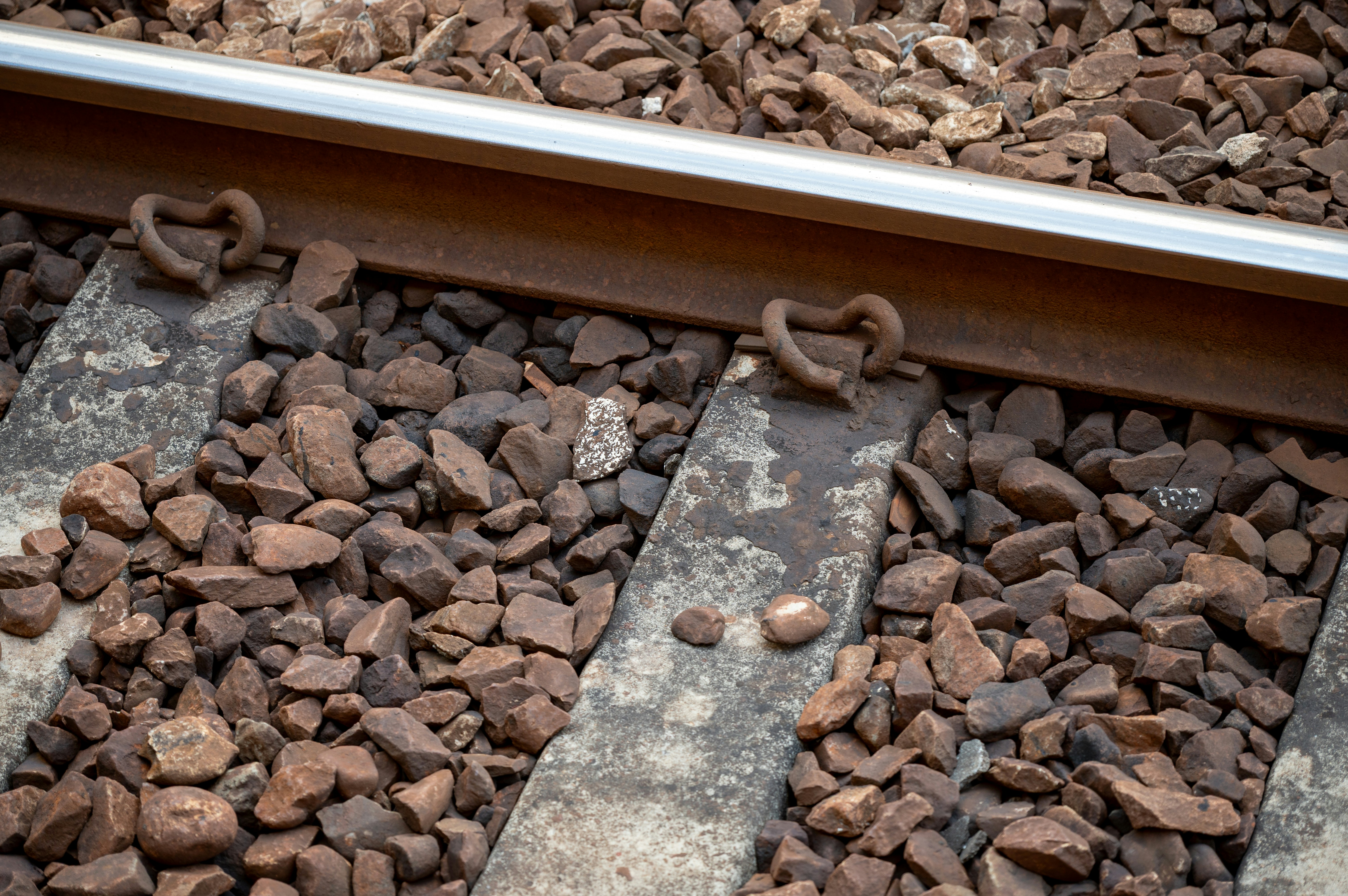 Close-up of rusty train tracks and gravel