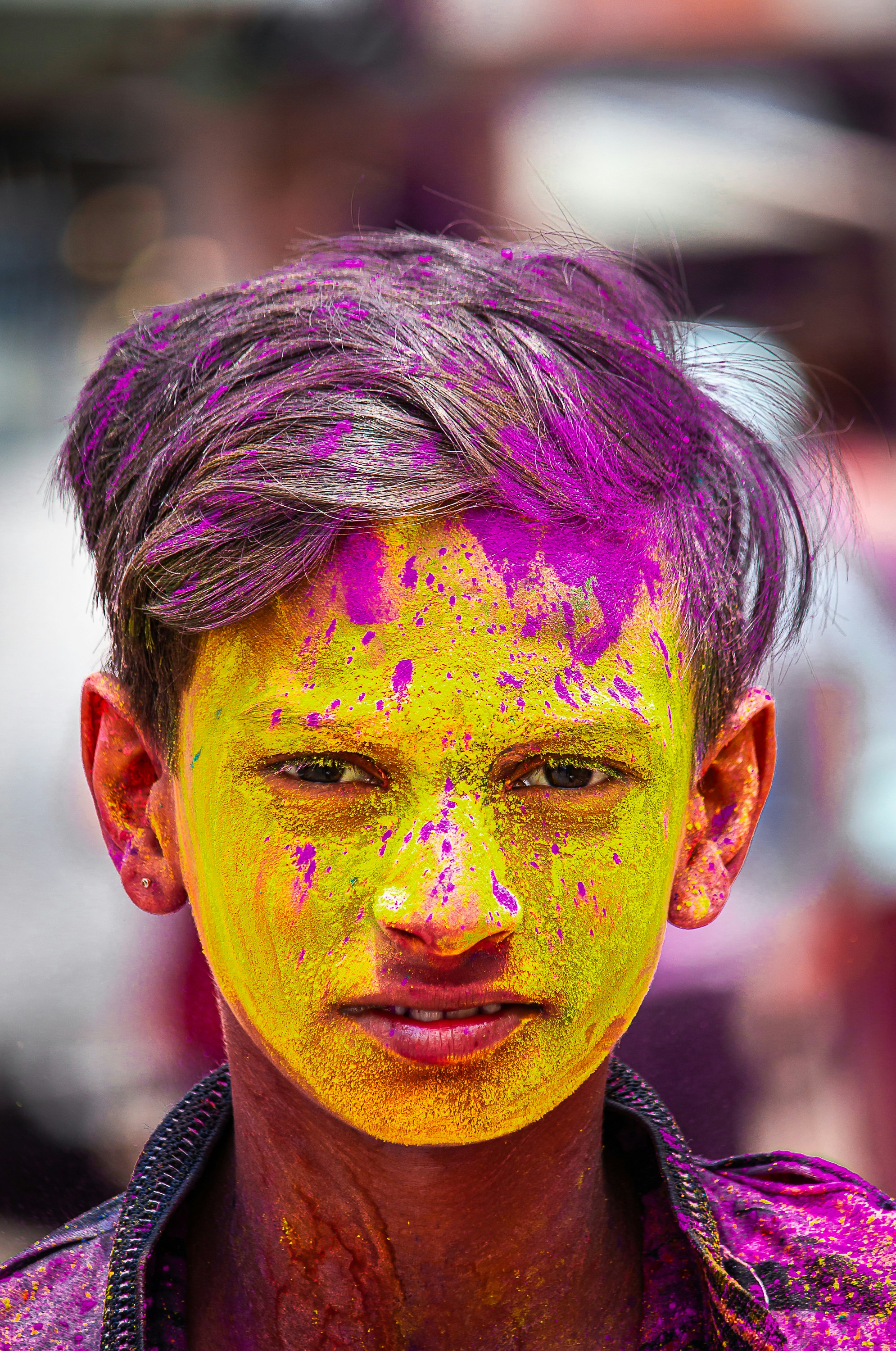 Young boy with colorful powder on his face