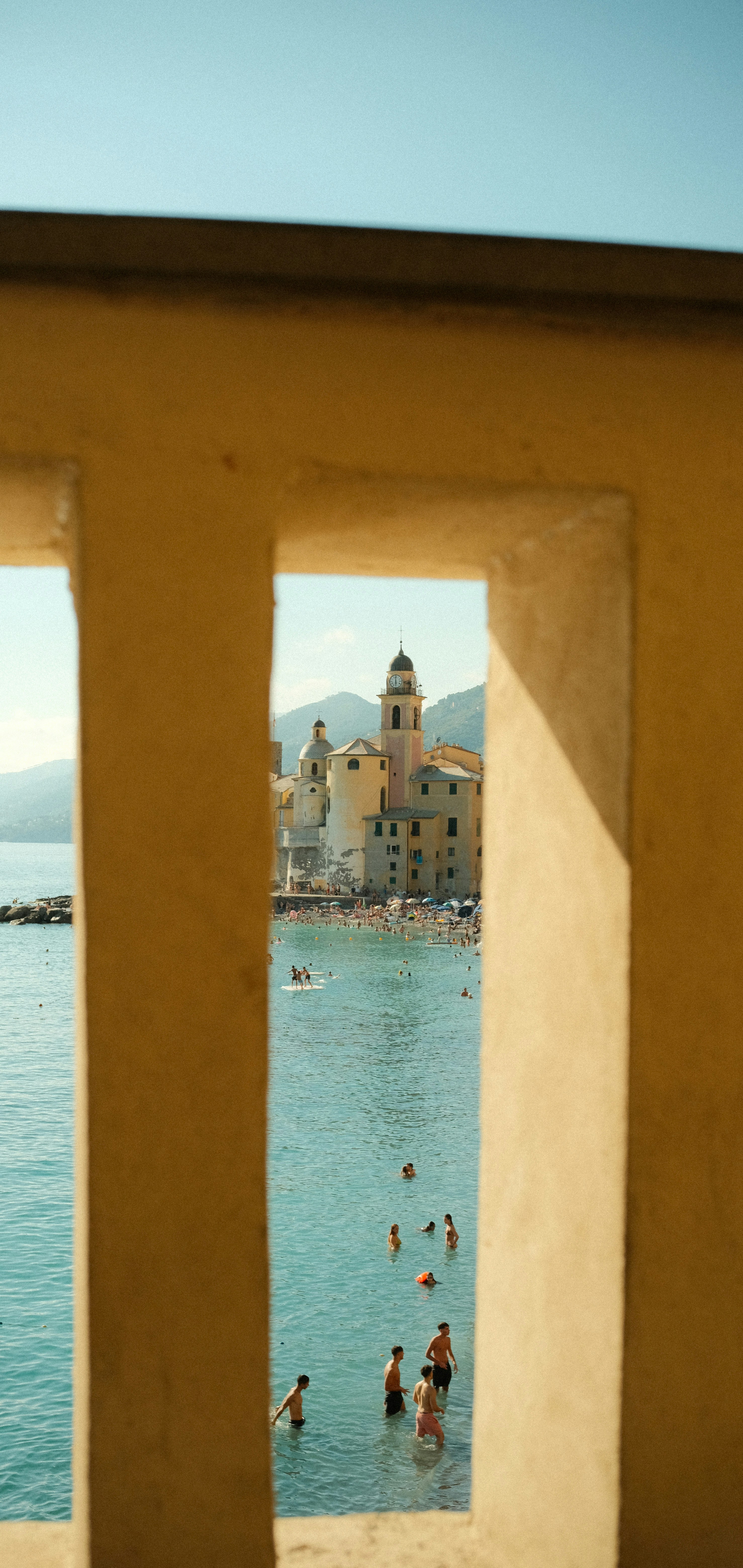 La gente nada en el océano cerca de una ciudad costera.