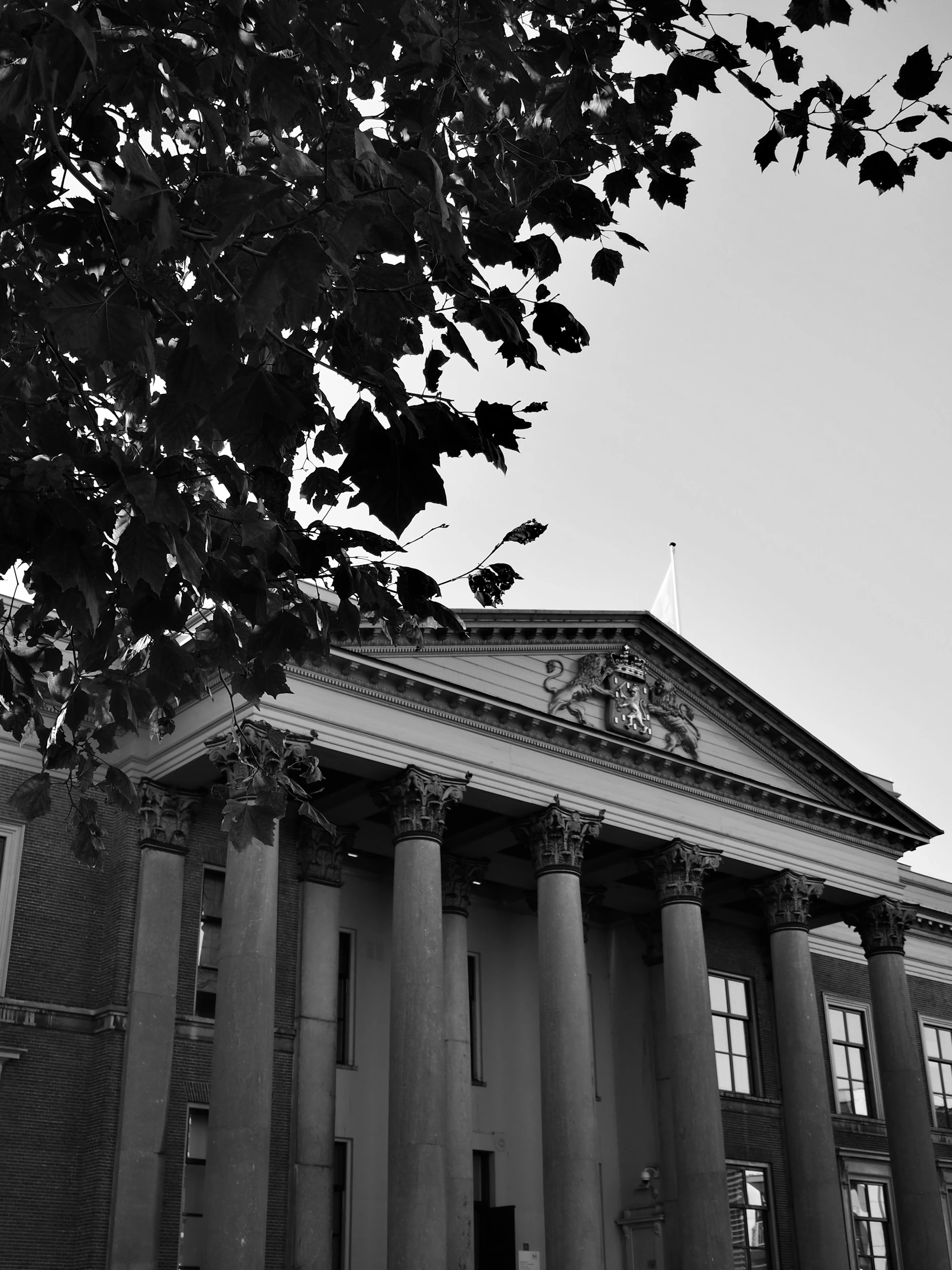 Grand building with columns and ornate pediment.