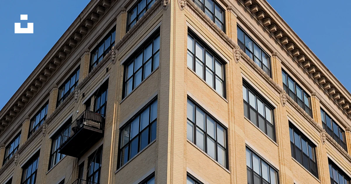 Tan Building Corner of a tan building against blue sky photo – Free Building Image ...