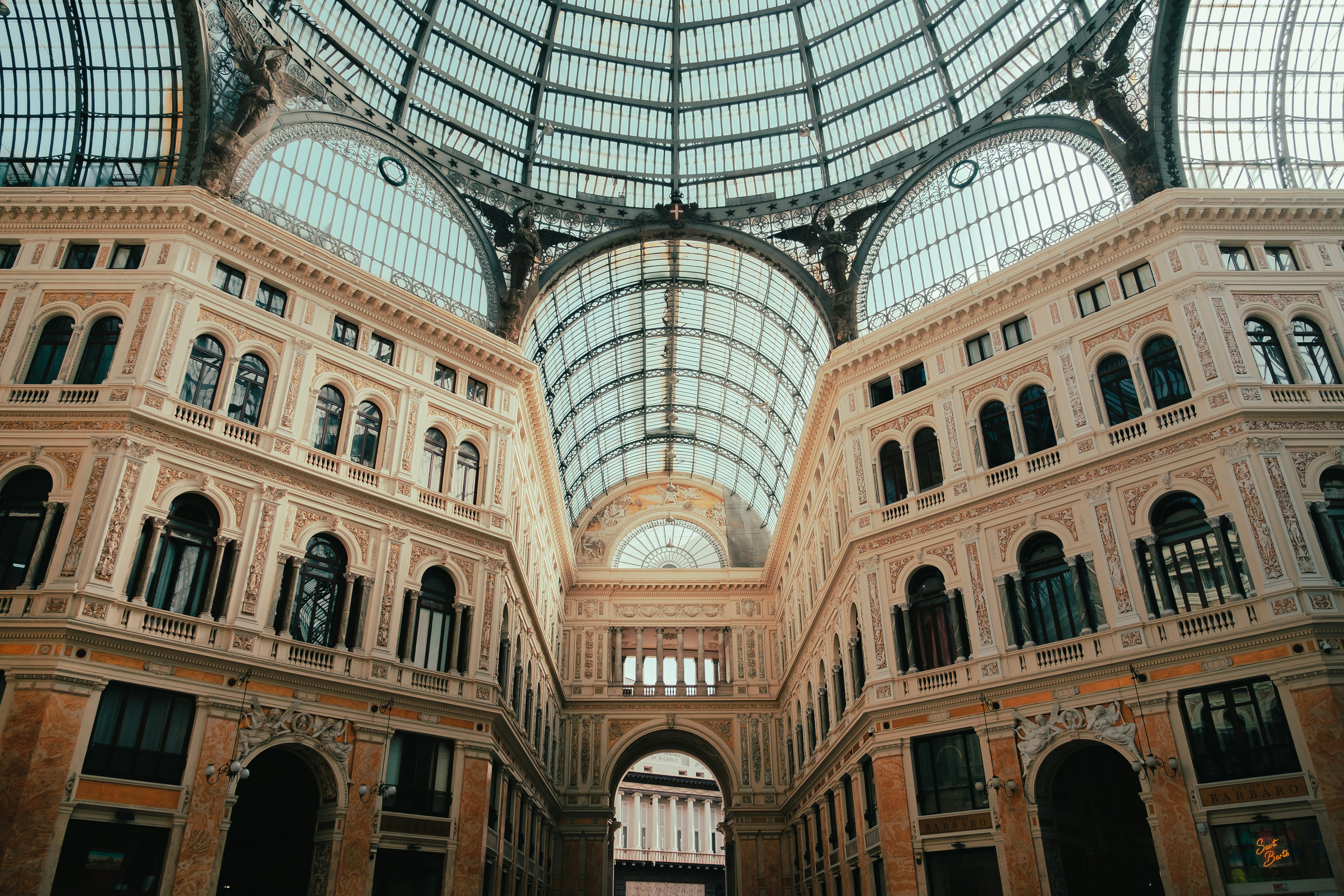 Grand interior of an ornate building with glass ceiling