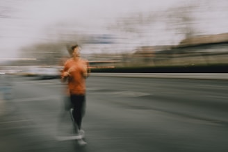 A person running on a street with motion blur.