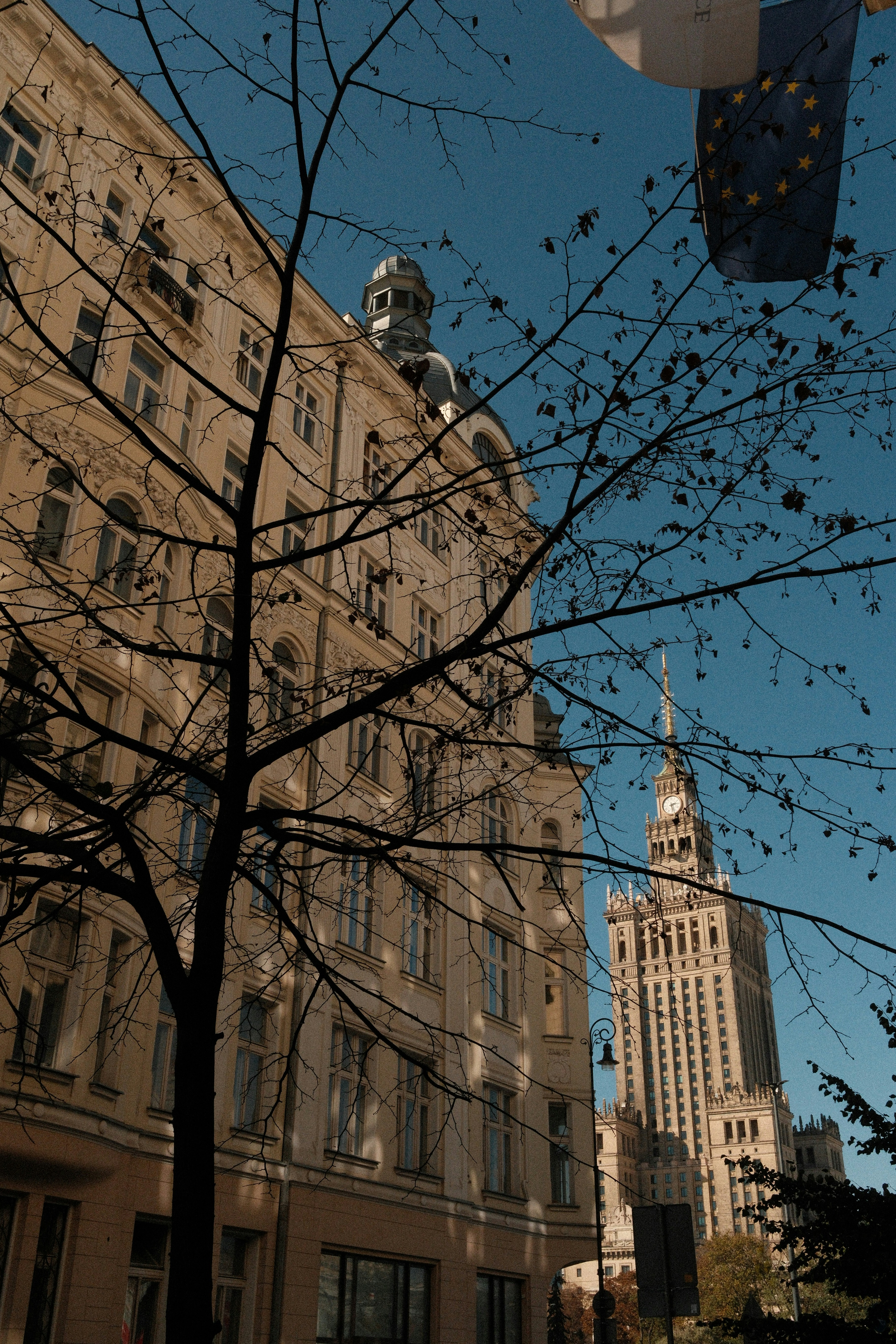 Old building and skyscraper under blue sky