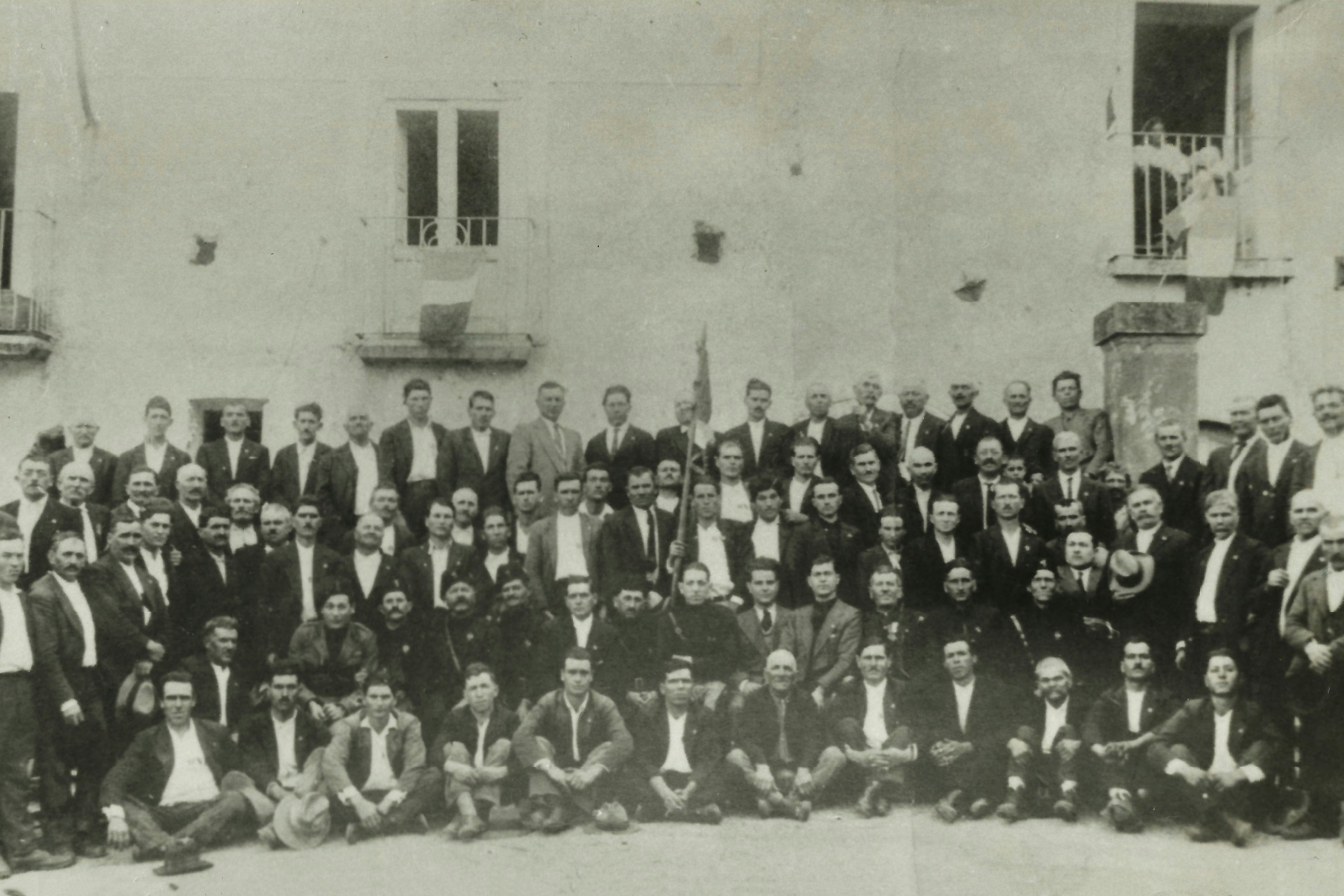Group of men posing for a formal outdoor gathering.