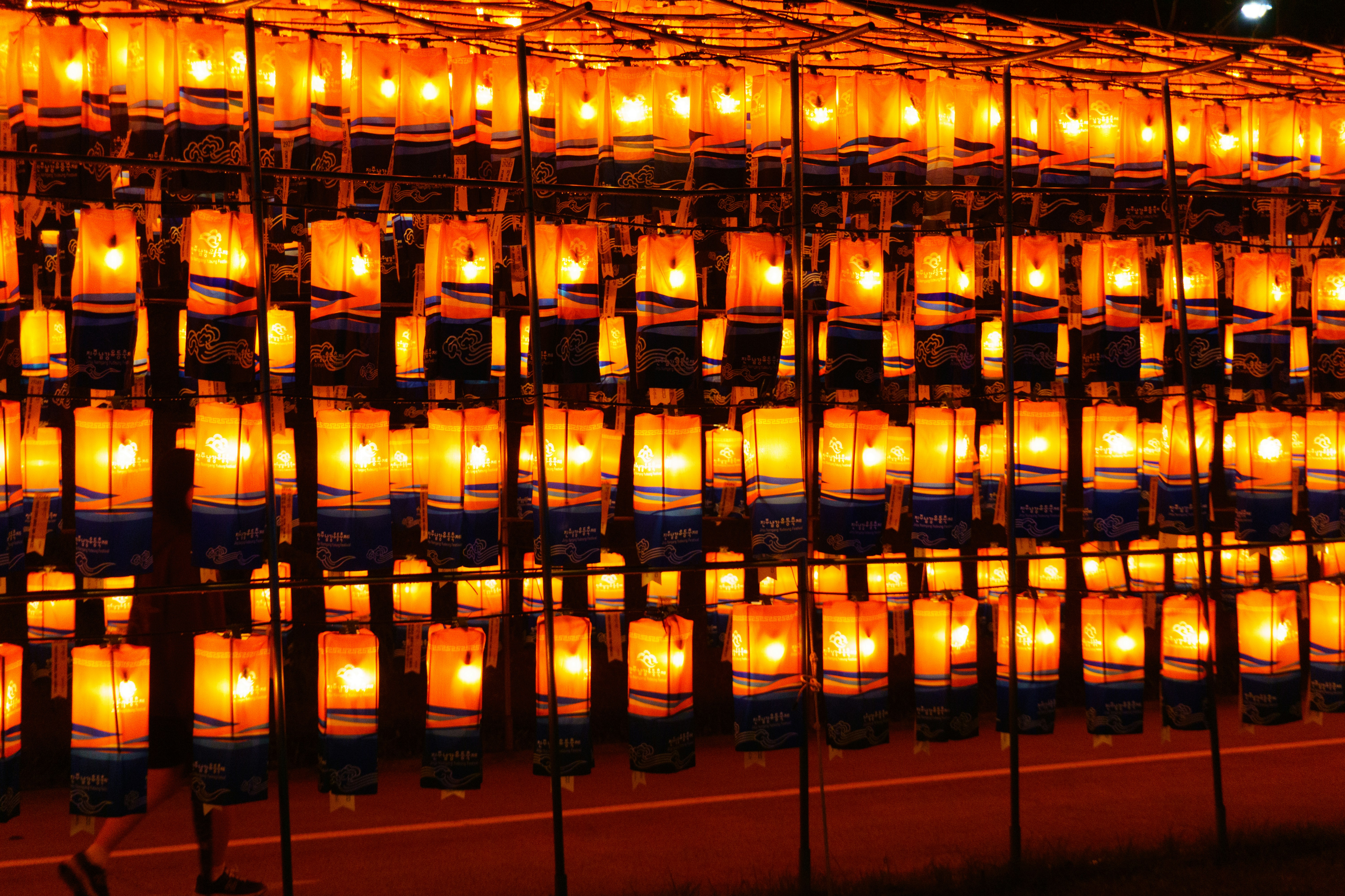 Rows of glowing lanterns illuminate the night