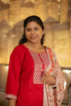 A smiling woman in a red outfit.