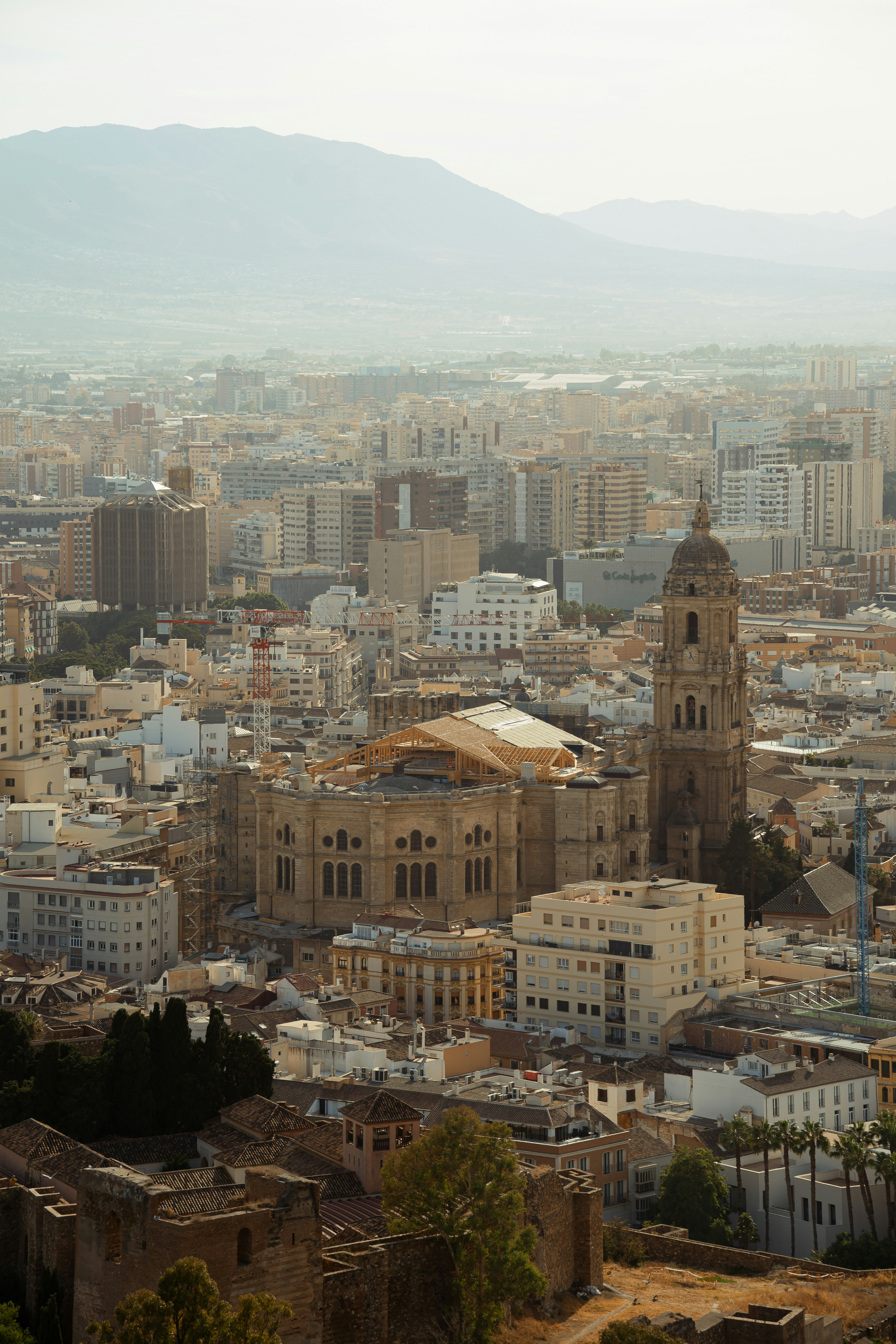 Cityscape with a prominent cathedral and distant mountains.