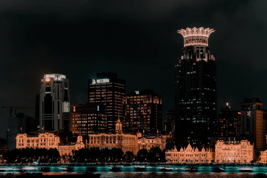 The Bund waterfront in Shanghai lit up at dusk with Pudong skyline across the river