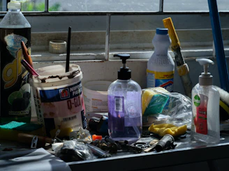 Assorted cleaning supplies and tools on a counter