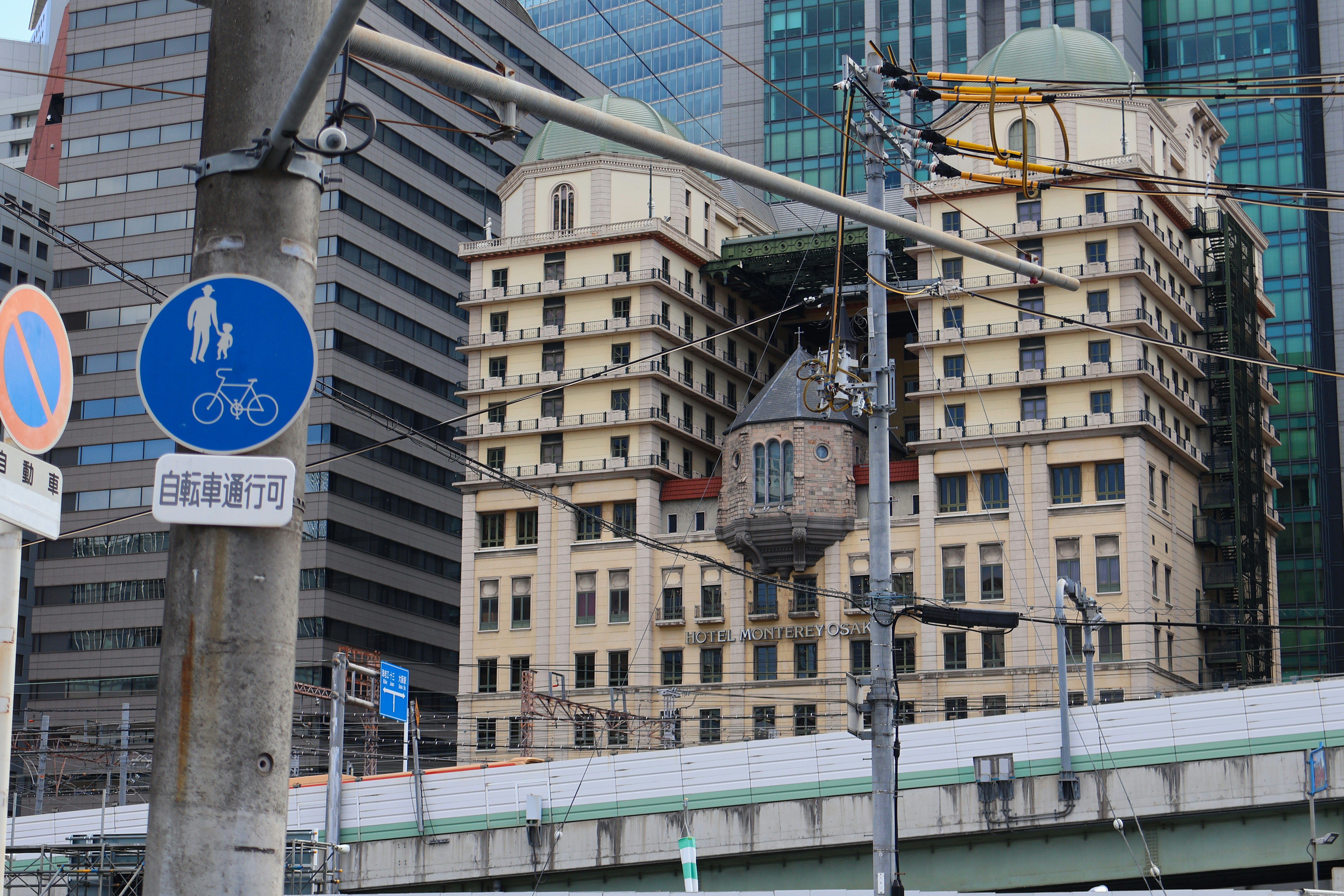 Ornate building with unique hanging structure in urban setting