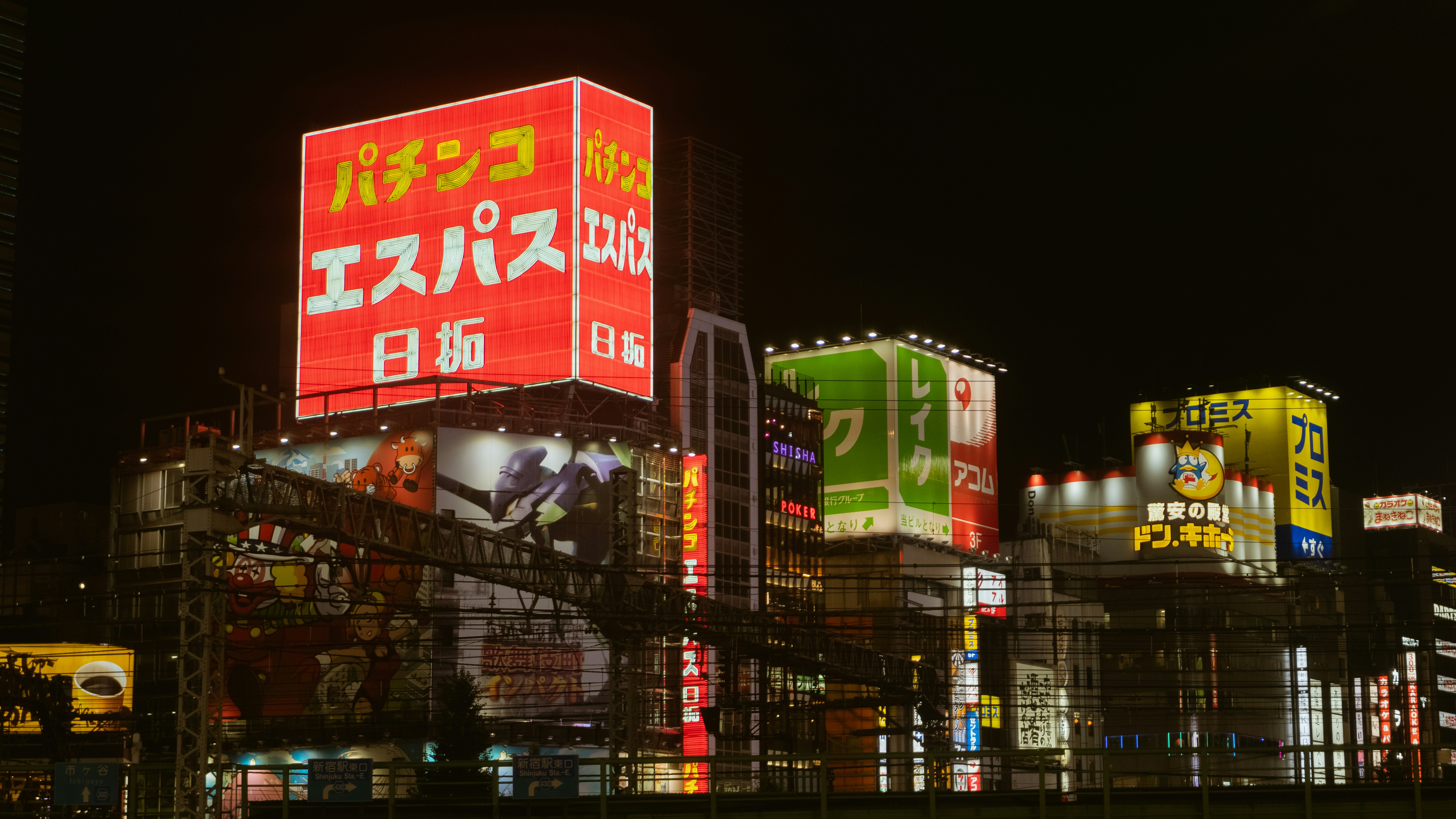 Shinjuku district at night with bright restaurant signs