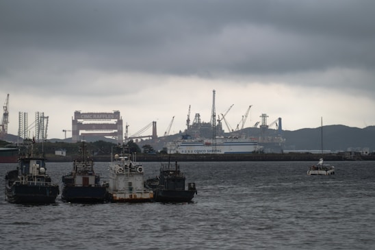 Tugboats in a harbor with industrial background