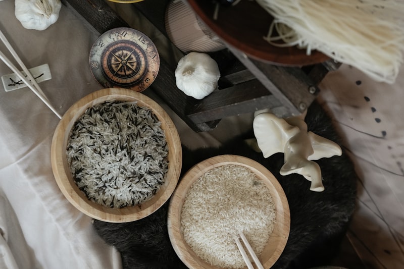 Fresh pasta nests and rolling pin dusted with flour on a wooden table
