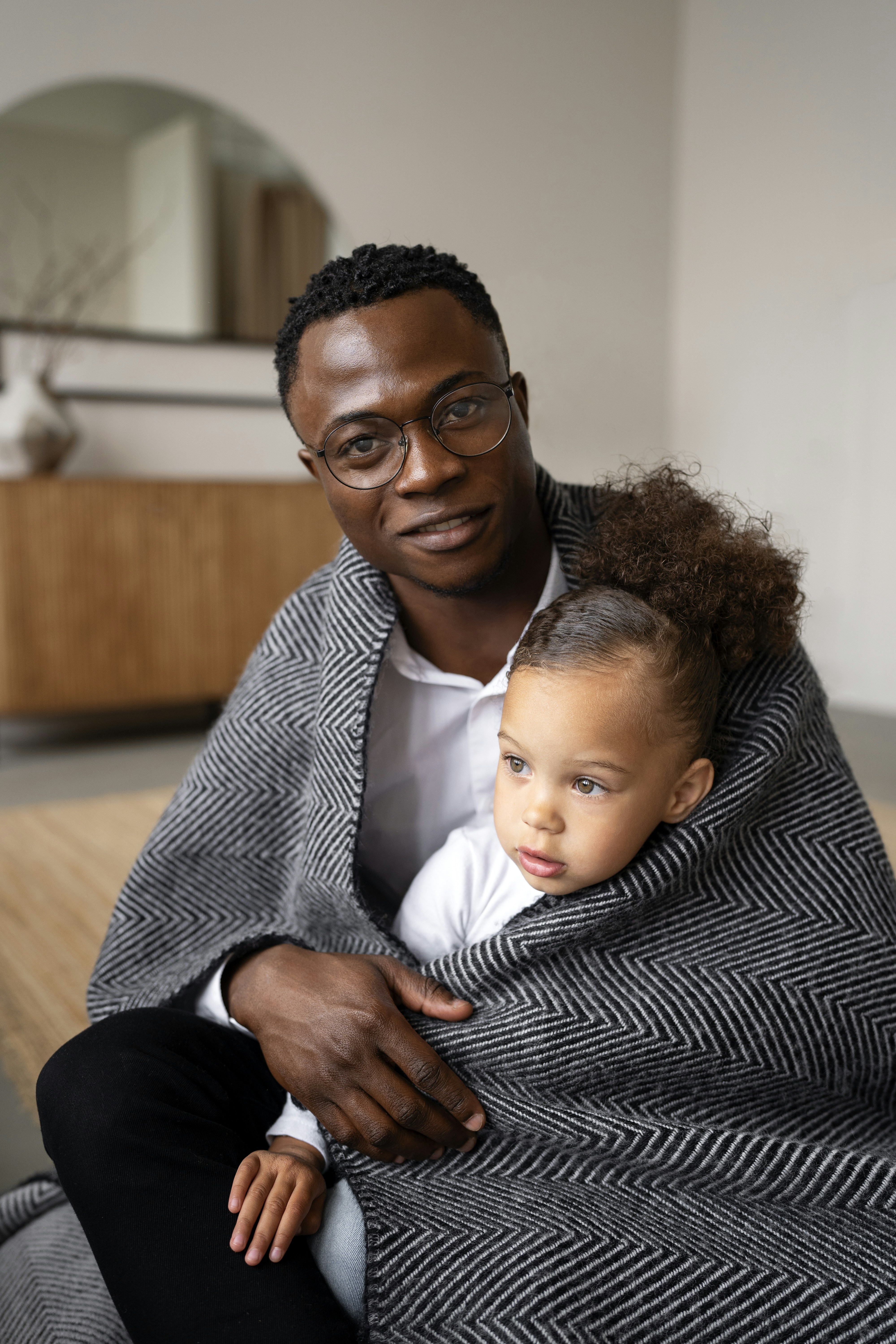 A father confidently holding his baby, the outcome that facilitative parenting protects against maternal gatekeeping