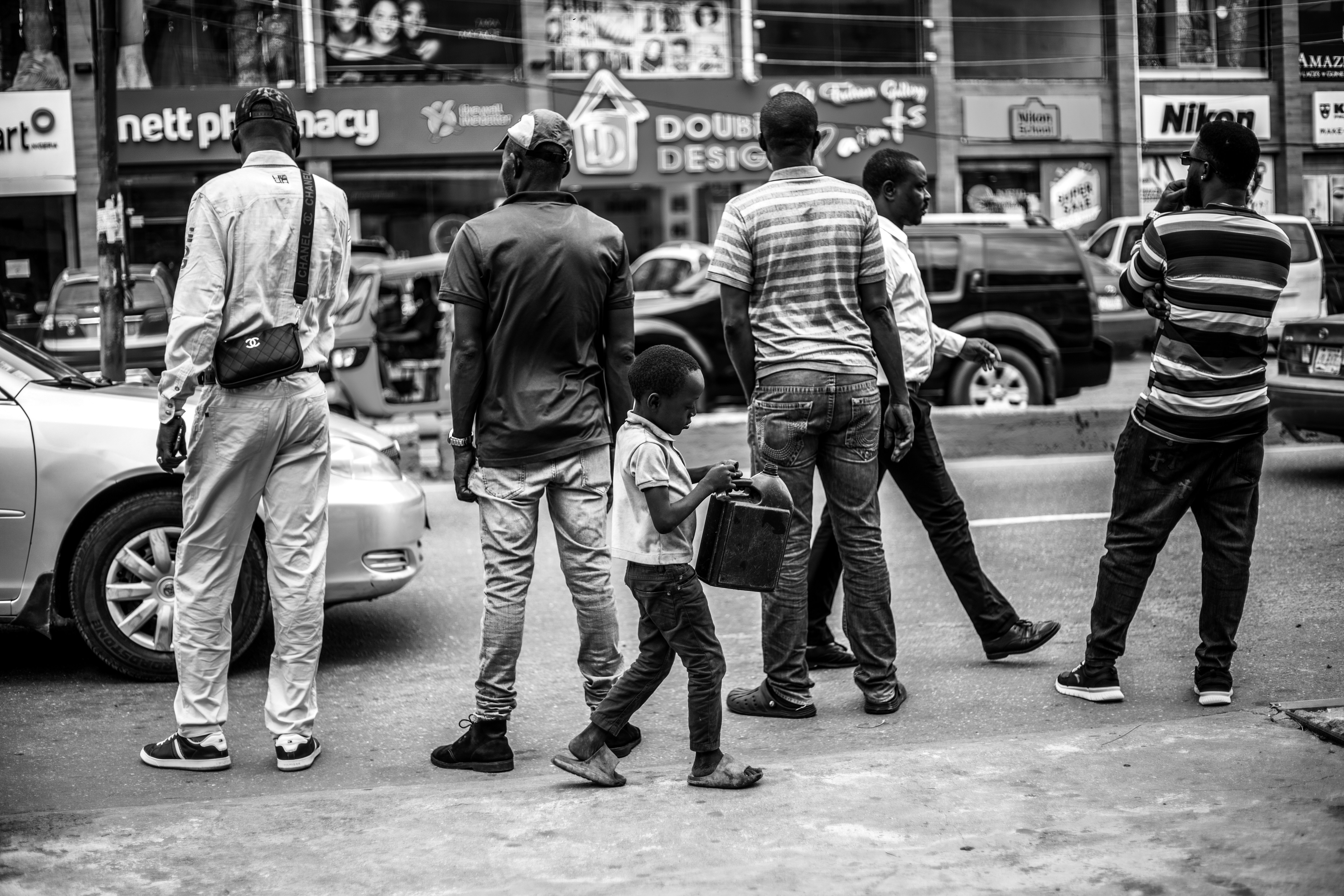 Group of men and a child on a city street.