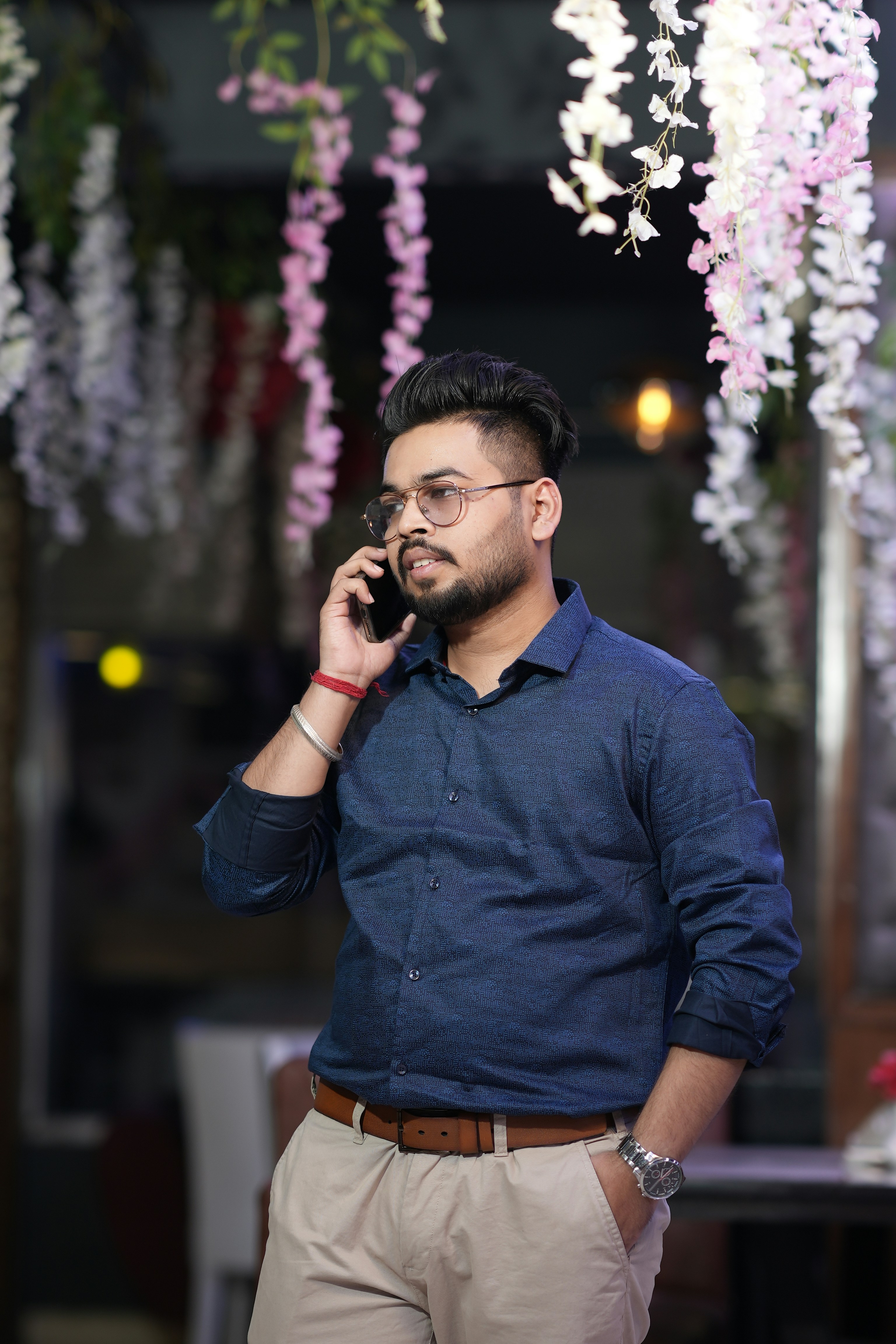 Man talking on a cell phone with floral decor