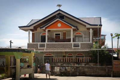 A two-story house with a unique architectural design.