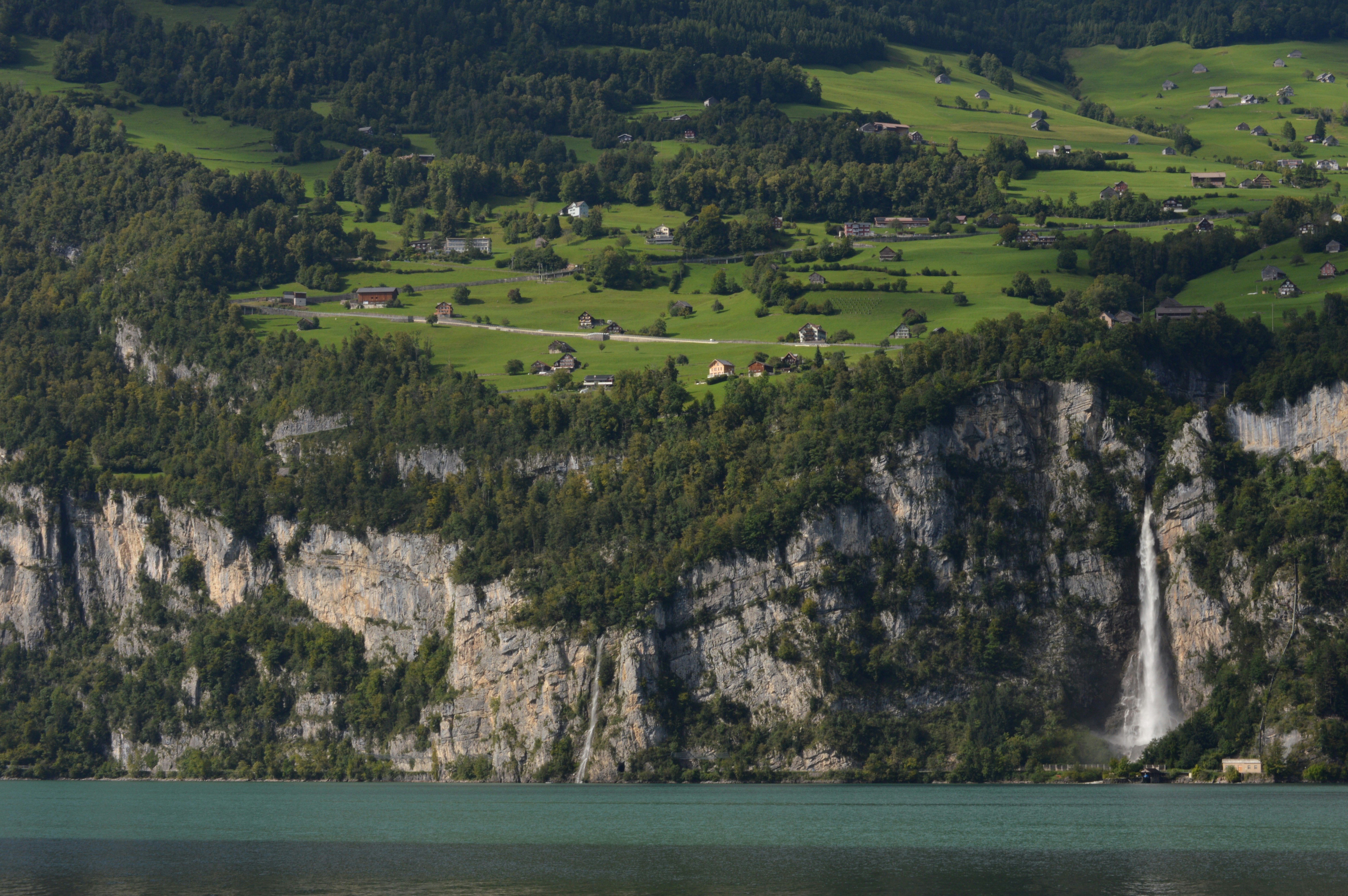 Waterfall cascading down a rocky cliff face into a lake