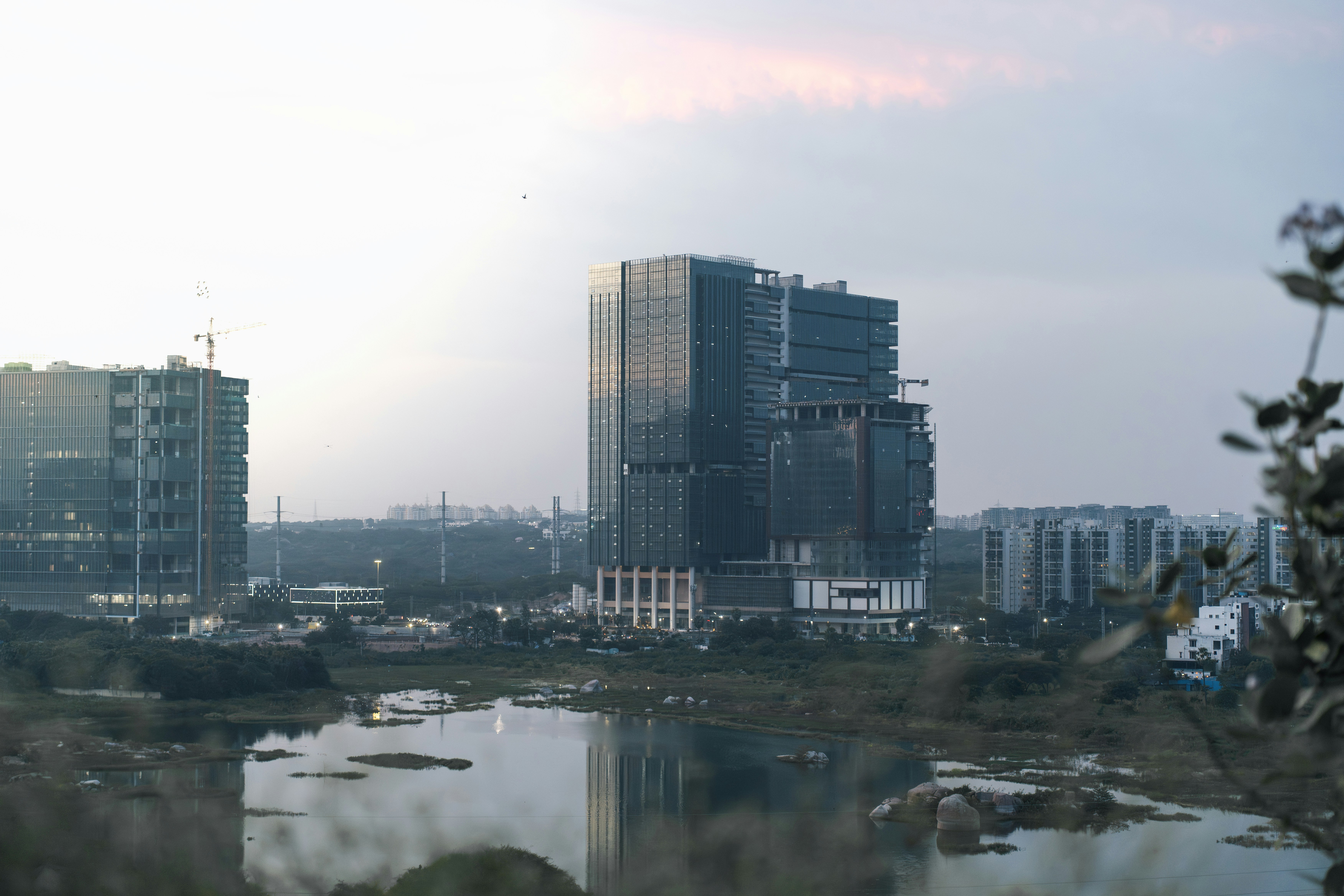 Modern buildings under construction near a body of water