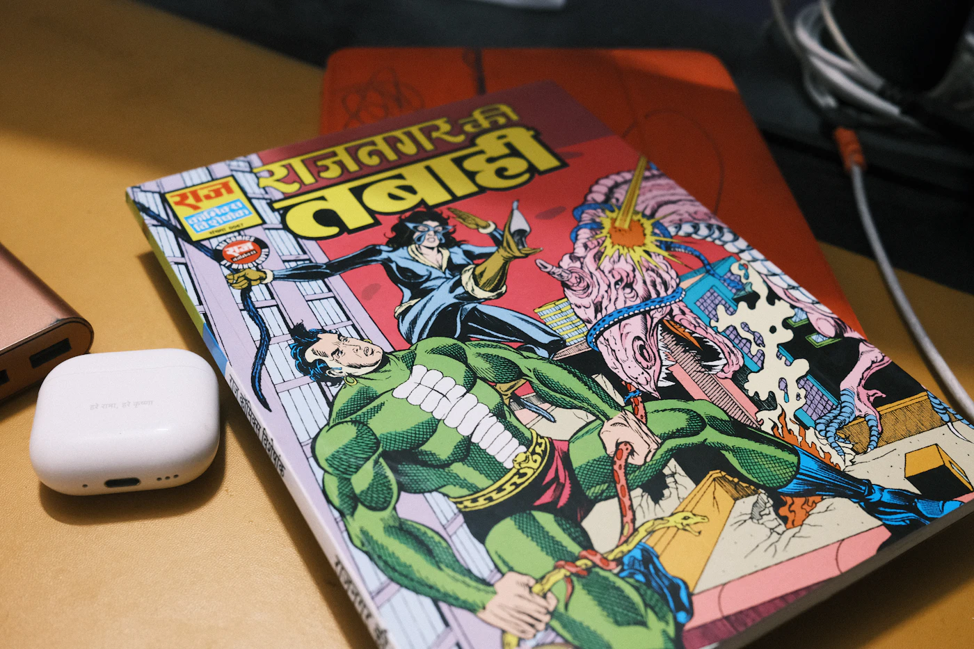 An open comic book with colour illustrations on a desk