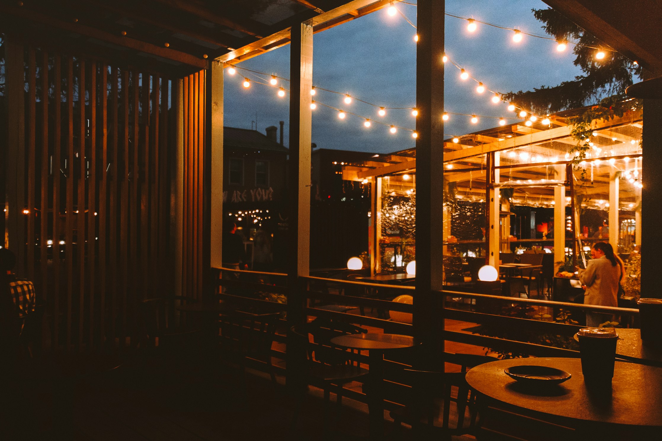 Outdoor patio strung with warm string lights at dusk