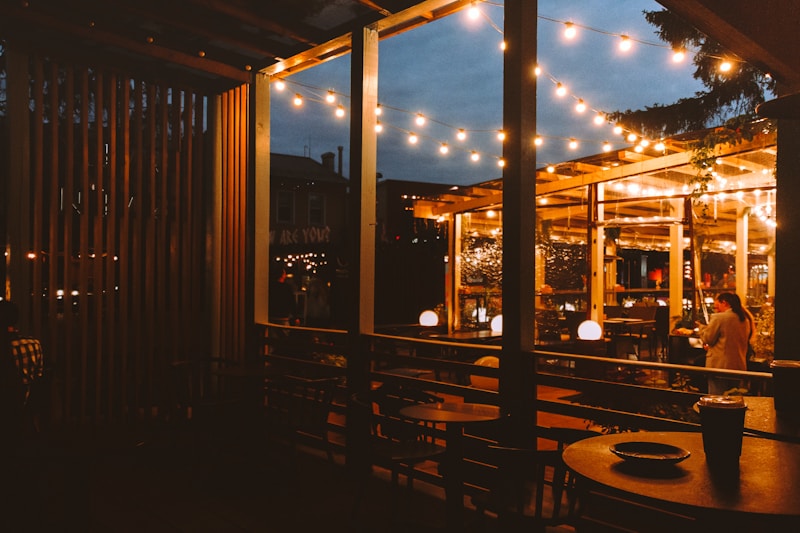 Outdoor cafe with string lights at dusk