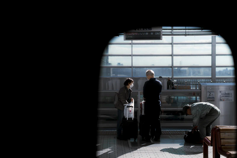 Two people talking at an airport with their luggage