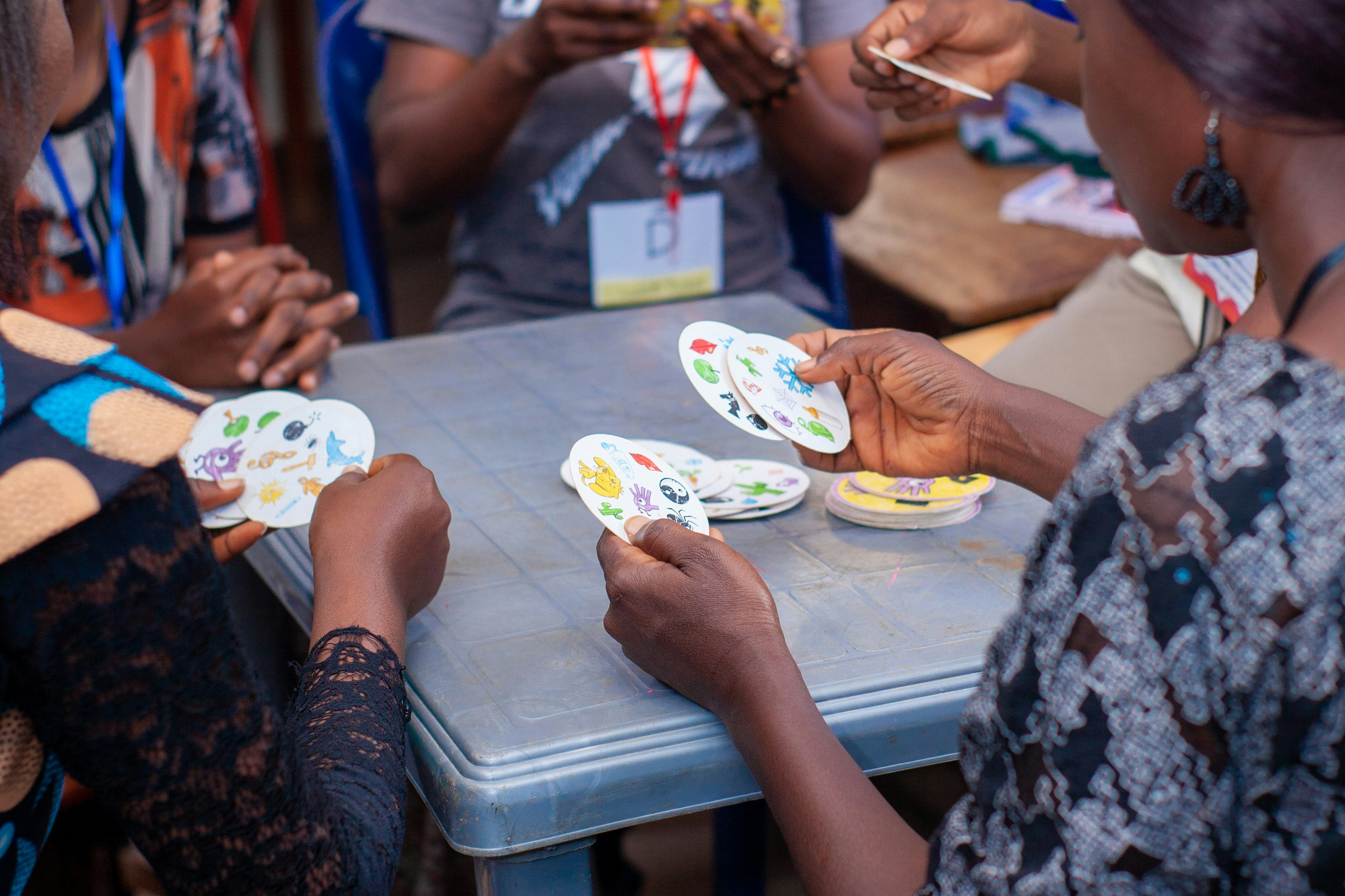 People playing a card game around a table