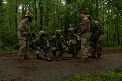 Soldiers gathered in a forest clearing during training.