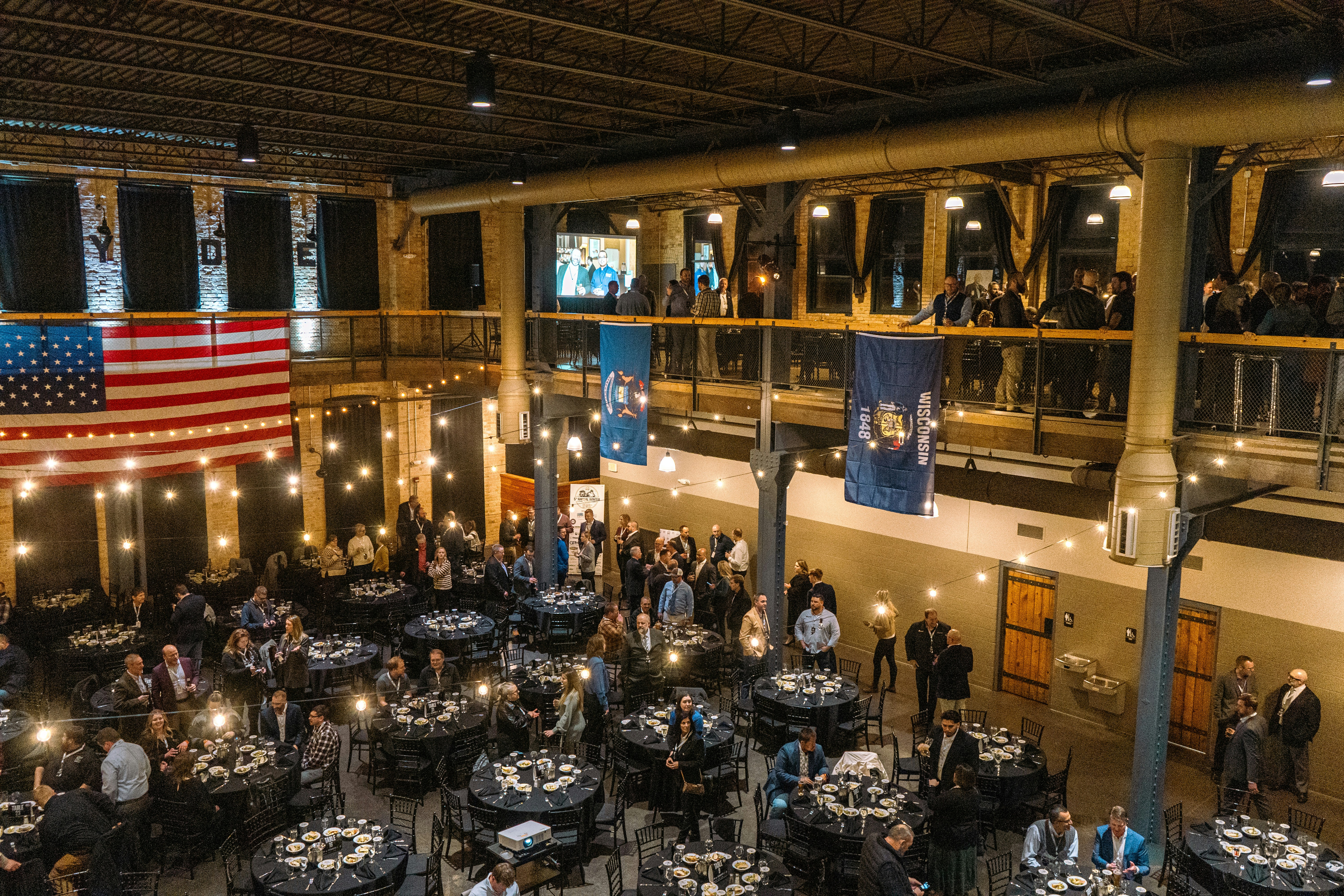 People gathered for an event in a large hall.