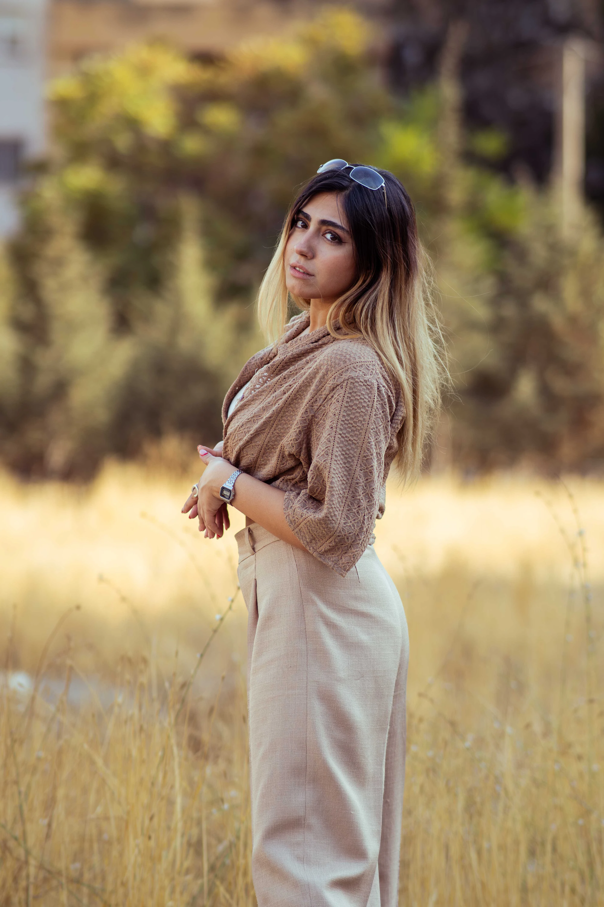 A woman in a field of dry grass