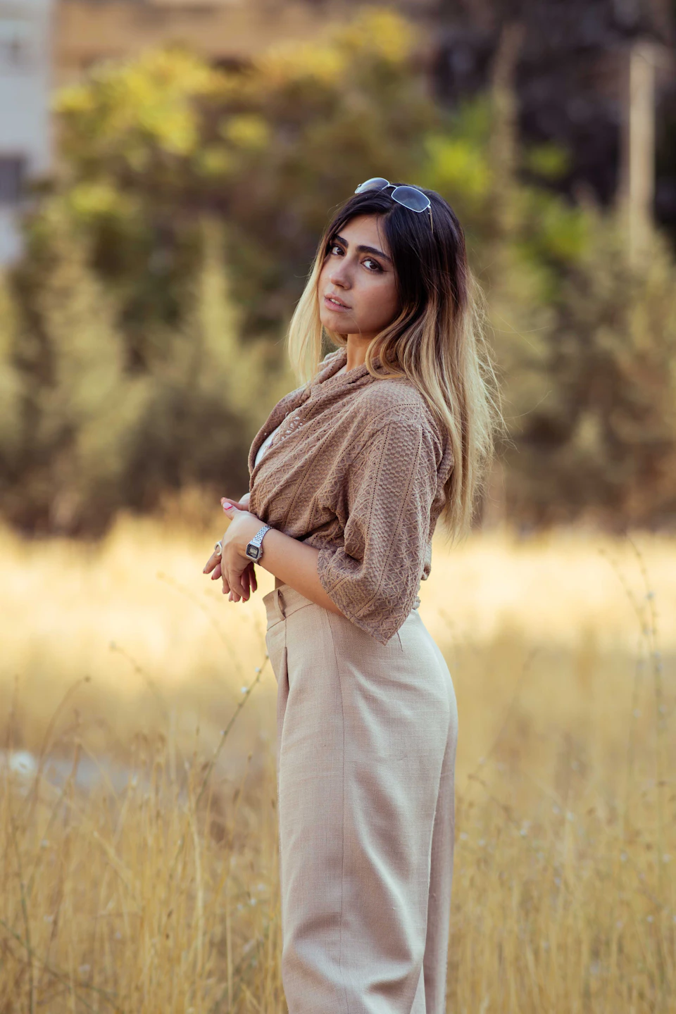 A woman in a field of dry grass