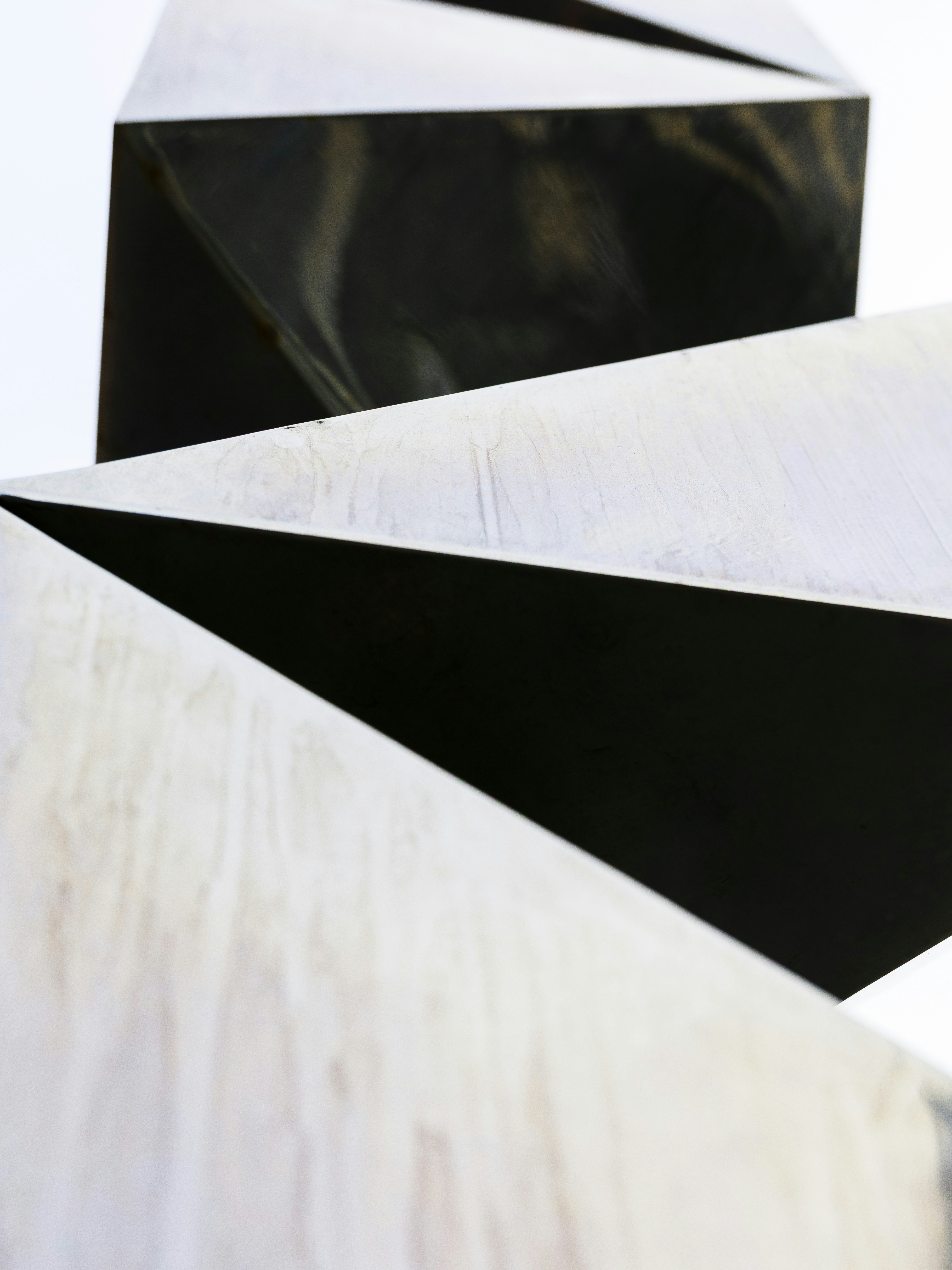 Abstract metallic sculpture with sharp geometric angles.